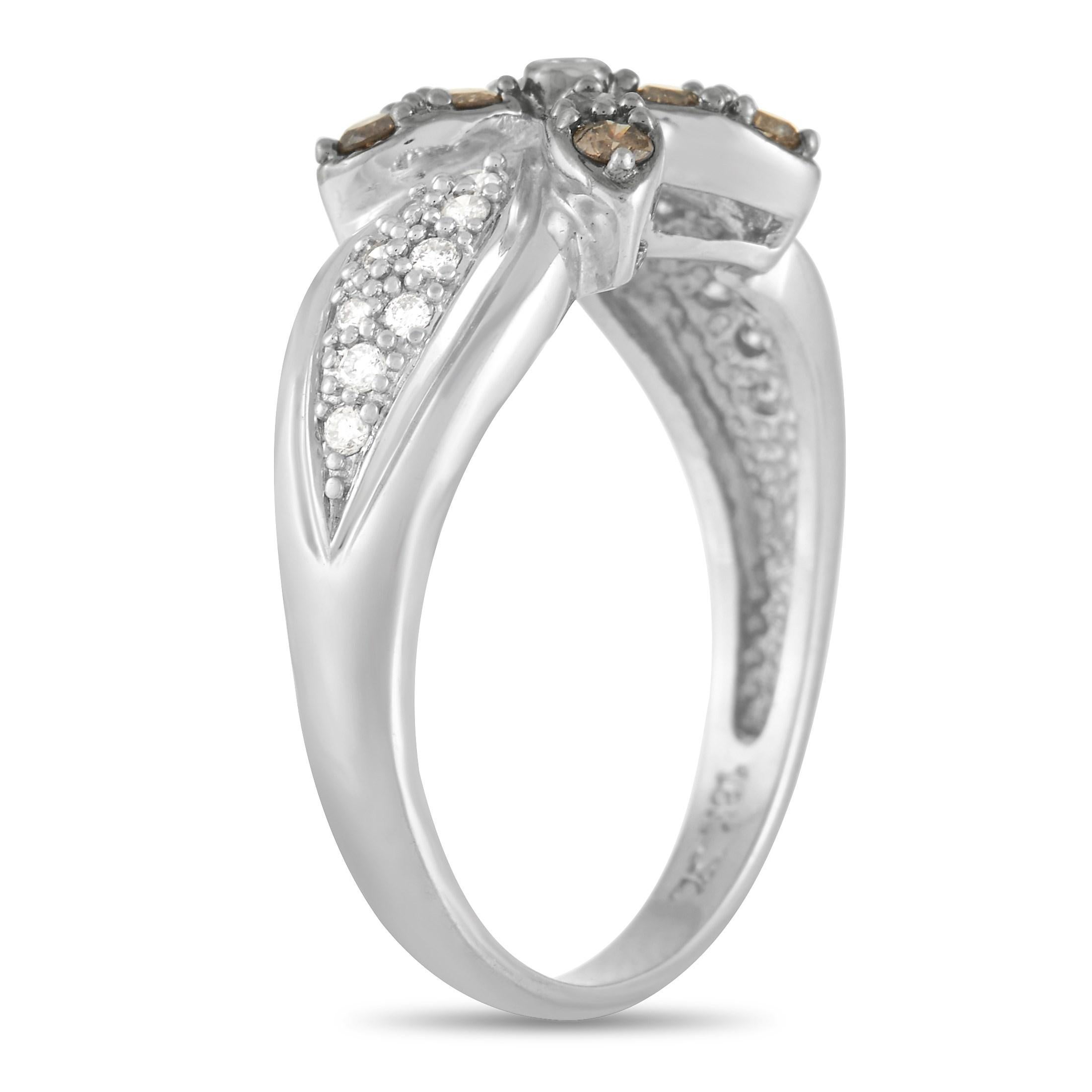 A fabulous floral motif sets this 18K White Gold ring from Le Vain apart in the best way possible. This impeccable piece’s 3mm wide band is adorned with shimmering white diamonds, while brown diamonds add a pop of color to the “petals.” A top height