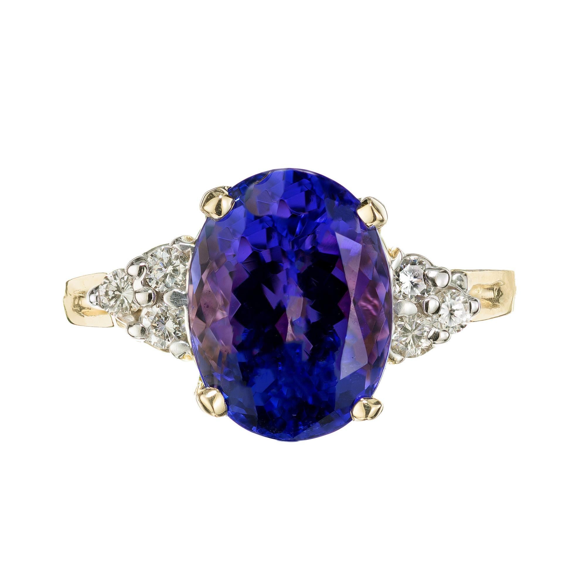 Exquisite bright purplish-blue oval 4.15 carat tanzanite diamond ring set in 14k yellow gold made by Le Vian. This mesmerizing ring features a stunning center tanzanite stone that radiates a captivating deep blue-violet hue, accented by 6 round