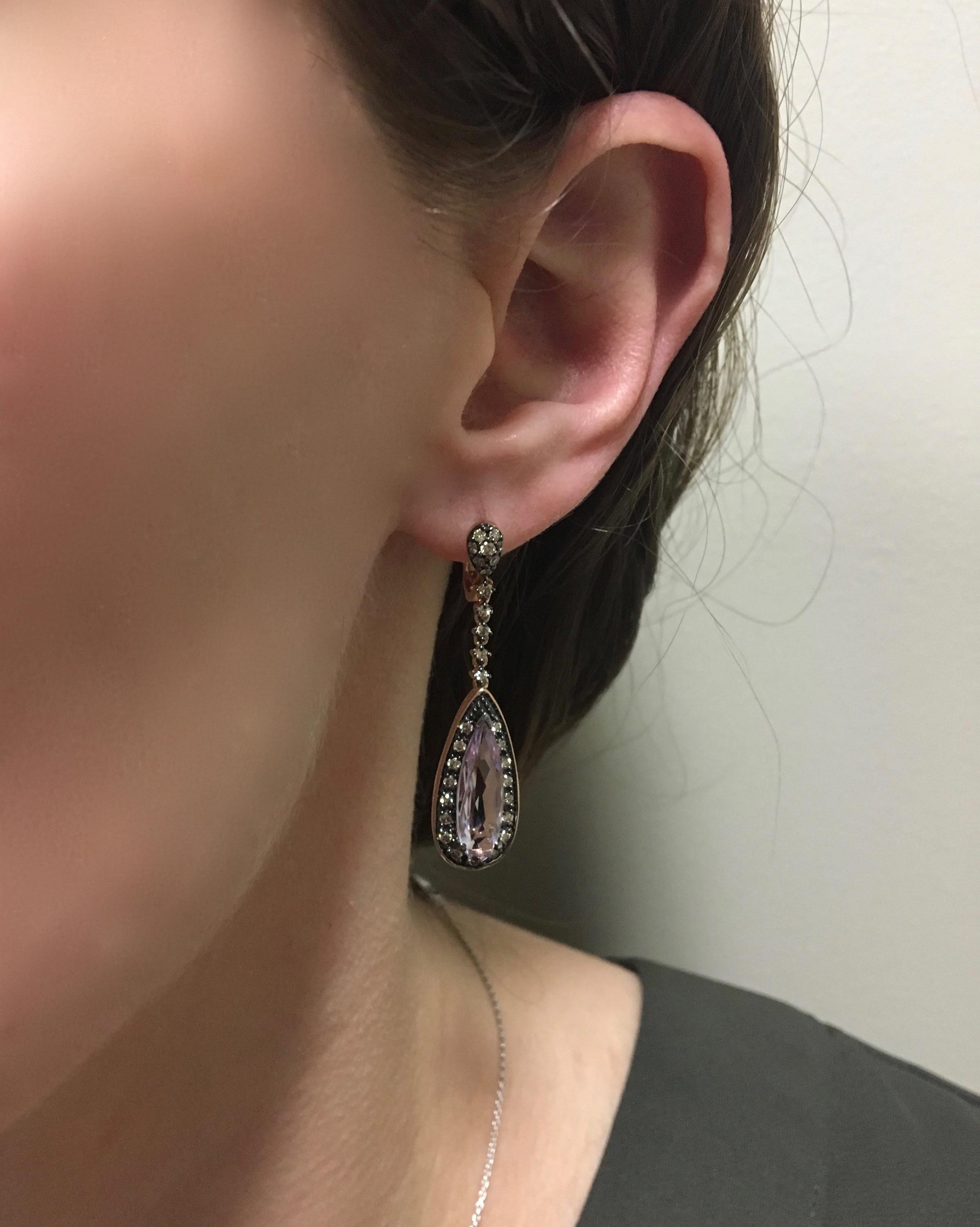 Beautiful Le Vian Amethyst Earrings Adorned with Chocolate Colored Diamonds

Designer: Le Vian
Gemstone: Two Elongated Pear Shaped Amethysts
Gemstone Size: Approximately 15.5 x 6mm 
Diamond Carat Weight: Approximately .60CTW
Diamond Cut: 60 Round