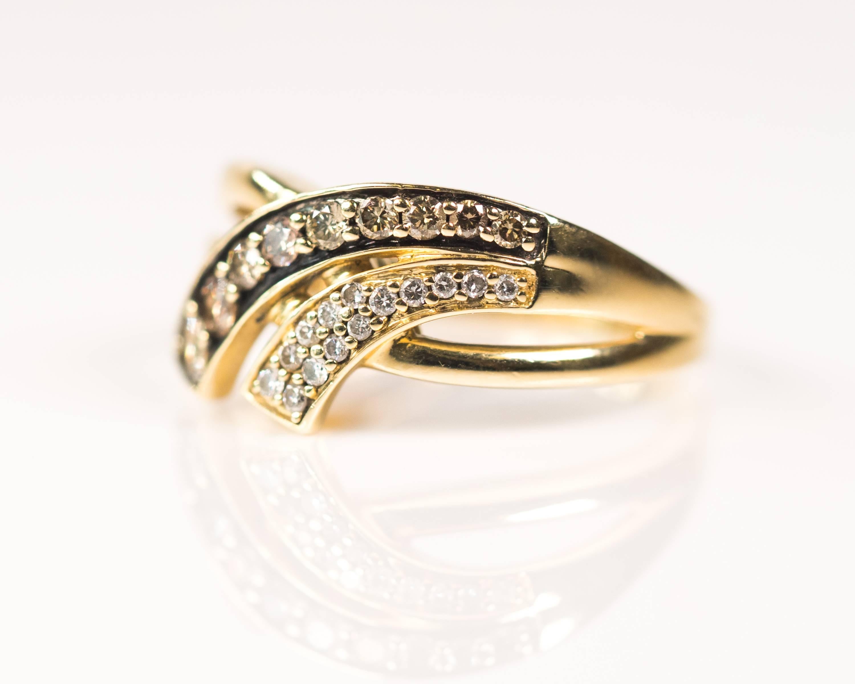 Le Vian Chocolate and White Diamond 14 Karat Yellow Gold Ring

Features 0.30 carats total weight of Diamonds and 14 Karat Yellow Gold Split Shank. The front of the ring has a split crossover ribbon design. The top ribbon segment is set with