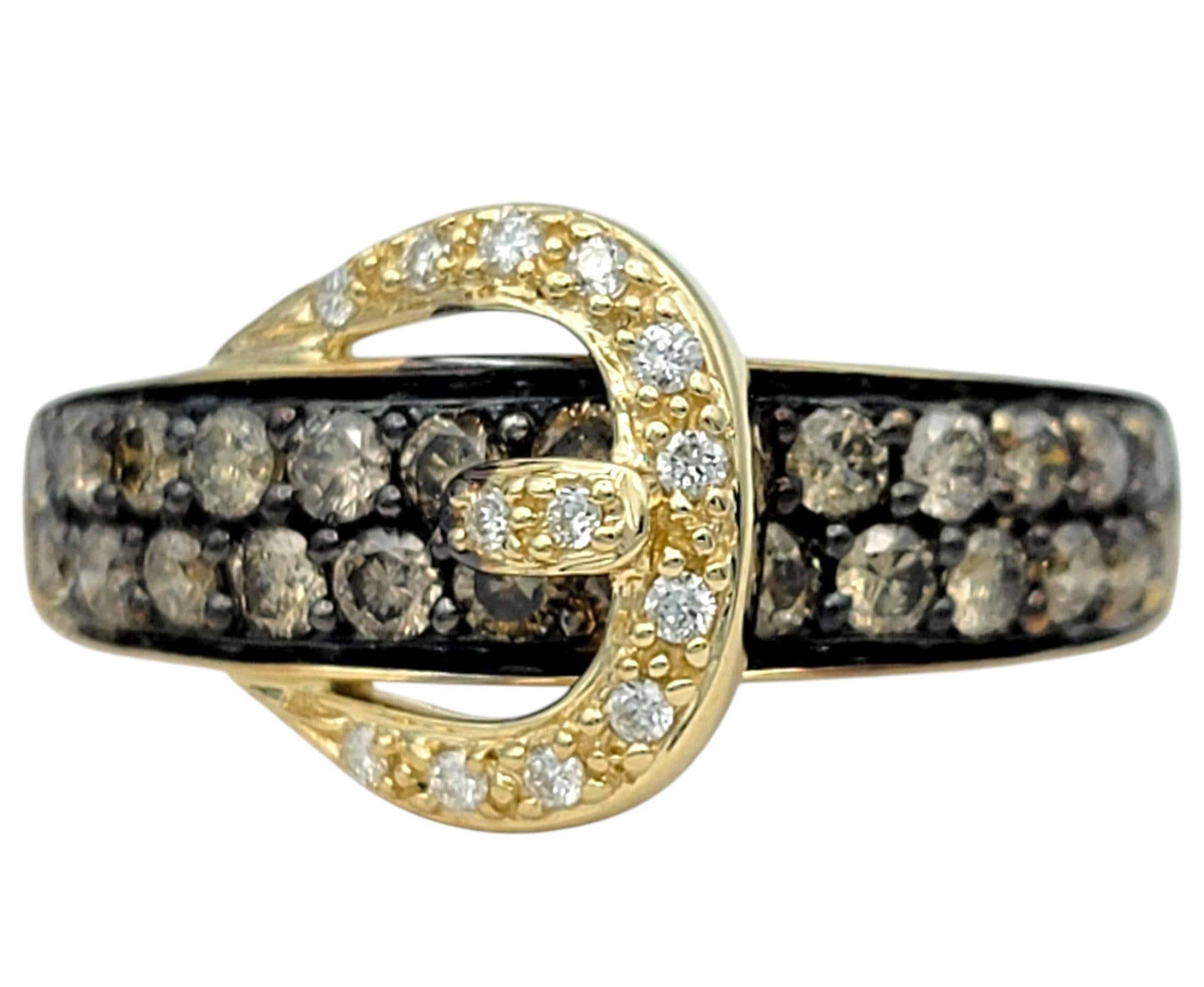 Ring Size: 6.75

A striking blend of elegance and bold design, this buckle motif ring by Le Vian is a true statement of style. Crafted in rich 14 karat yellow gold, this distinctive piece features a dazzling array of chocolate diamonds, set against