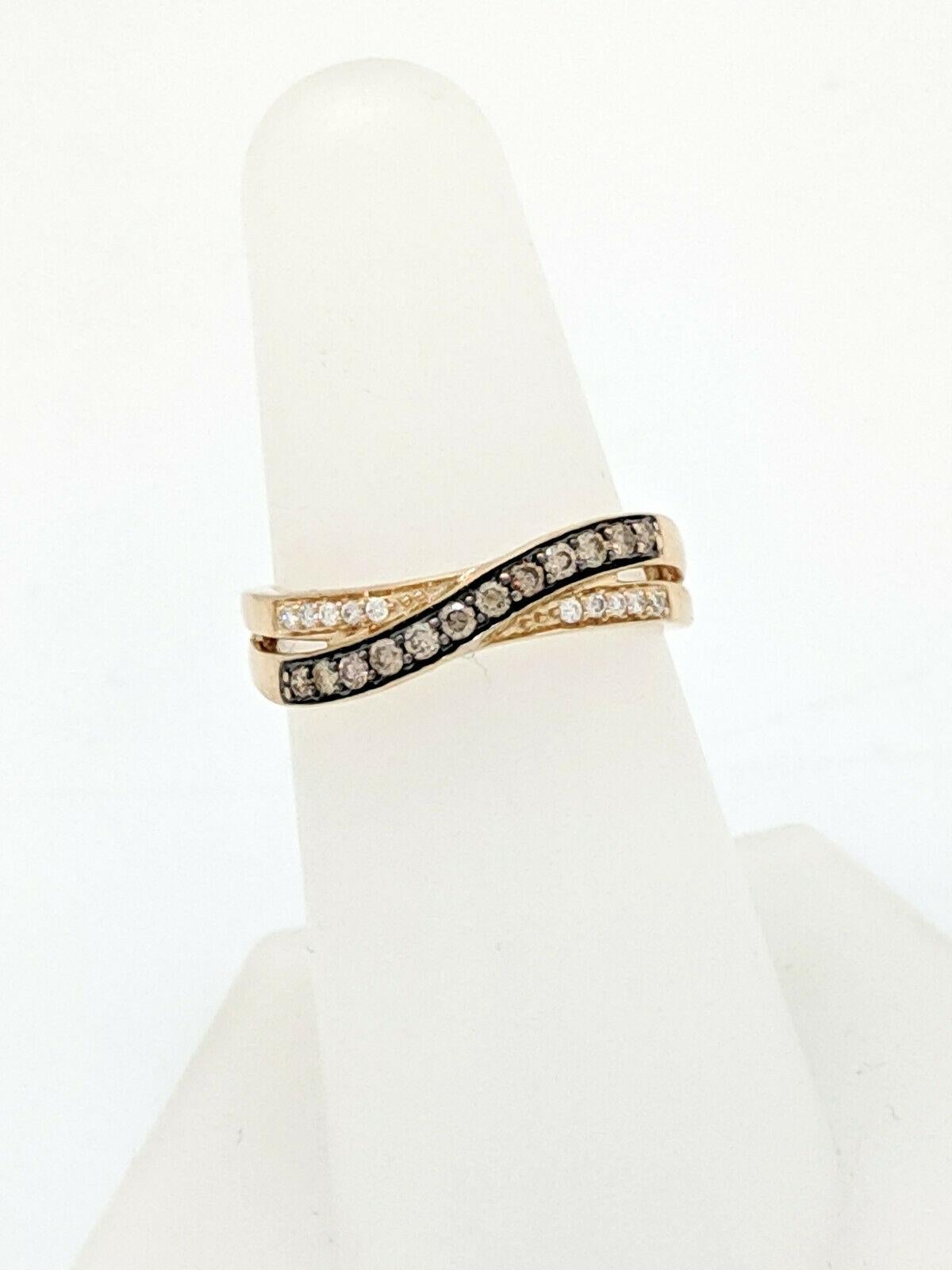 You are viewing a beautiful, twisting fashion ring by Le Vian.

This ring is crafted from 14k honey (yellow) gold and weighs 3 grams. The top of the ring measures 3mm in width and the bottom shank measures 2mm in width. It features 1/4ctw natural