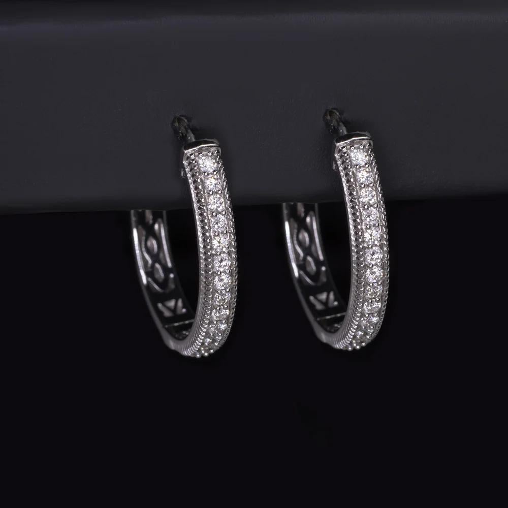 These refined diamond hoop earrings by Le Vian blend timeless elegance with subtle vintage-inspired details. Crafted in luminous 14k white gold and signed by the renowned house of Le Vian, they offer a touch of everyday luxury with a gracefully