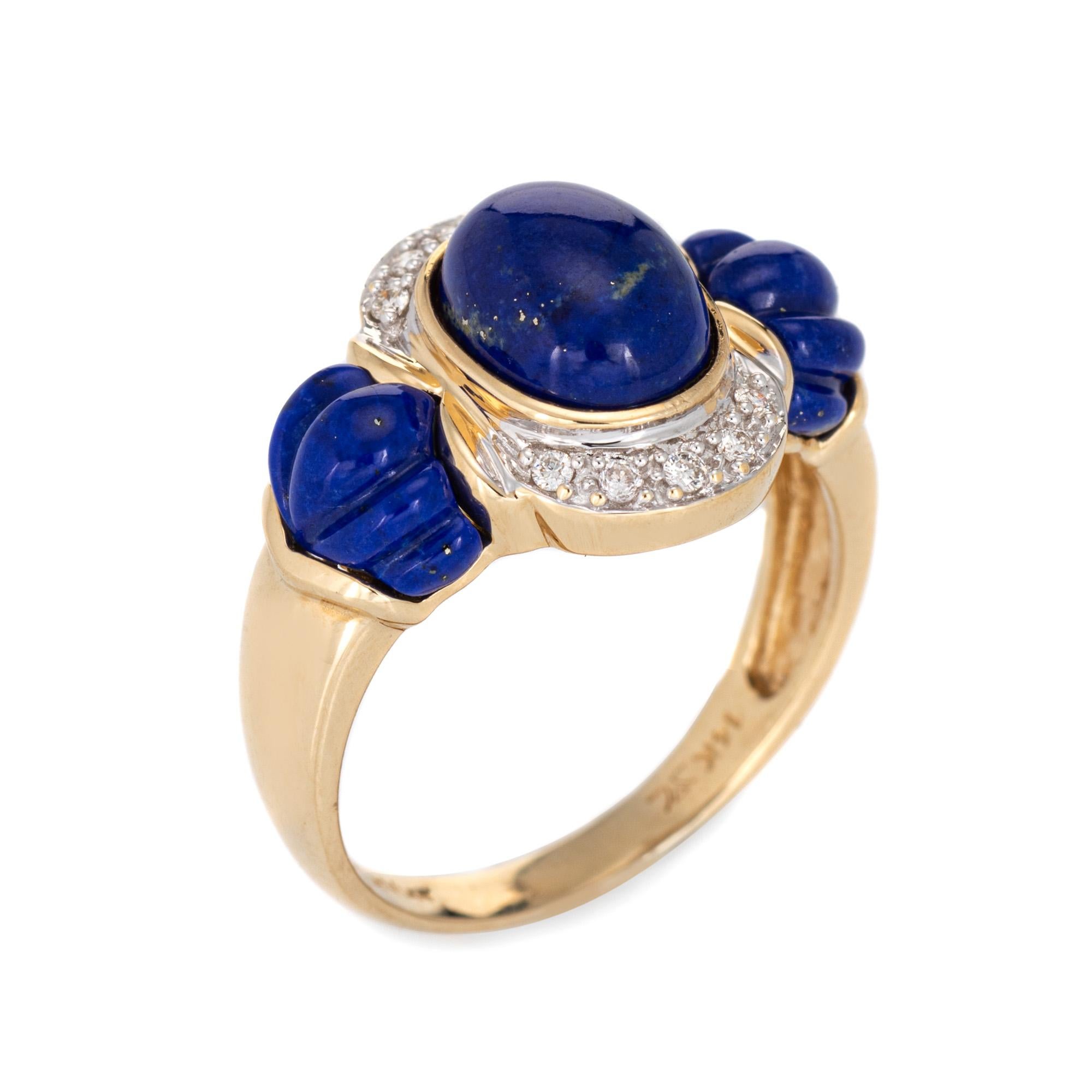 Stylish estate Le Vian lapis lazuli diamond cocktail ring crafted in 14 karat yellow gold. 

Cabochon cut lapis lazuli measures 8mm x 6mm with fluted lapis lazuli to the side shoulders (7mm x 5mm). Diamonds total an estimated 0.10 carat (estimated