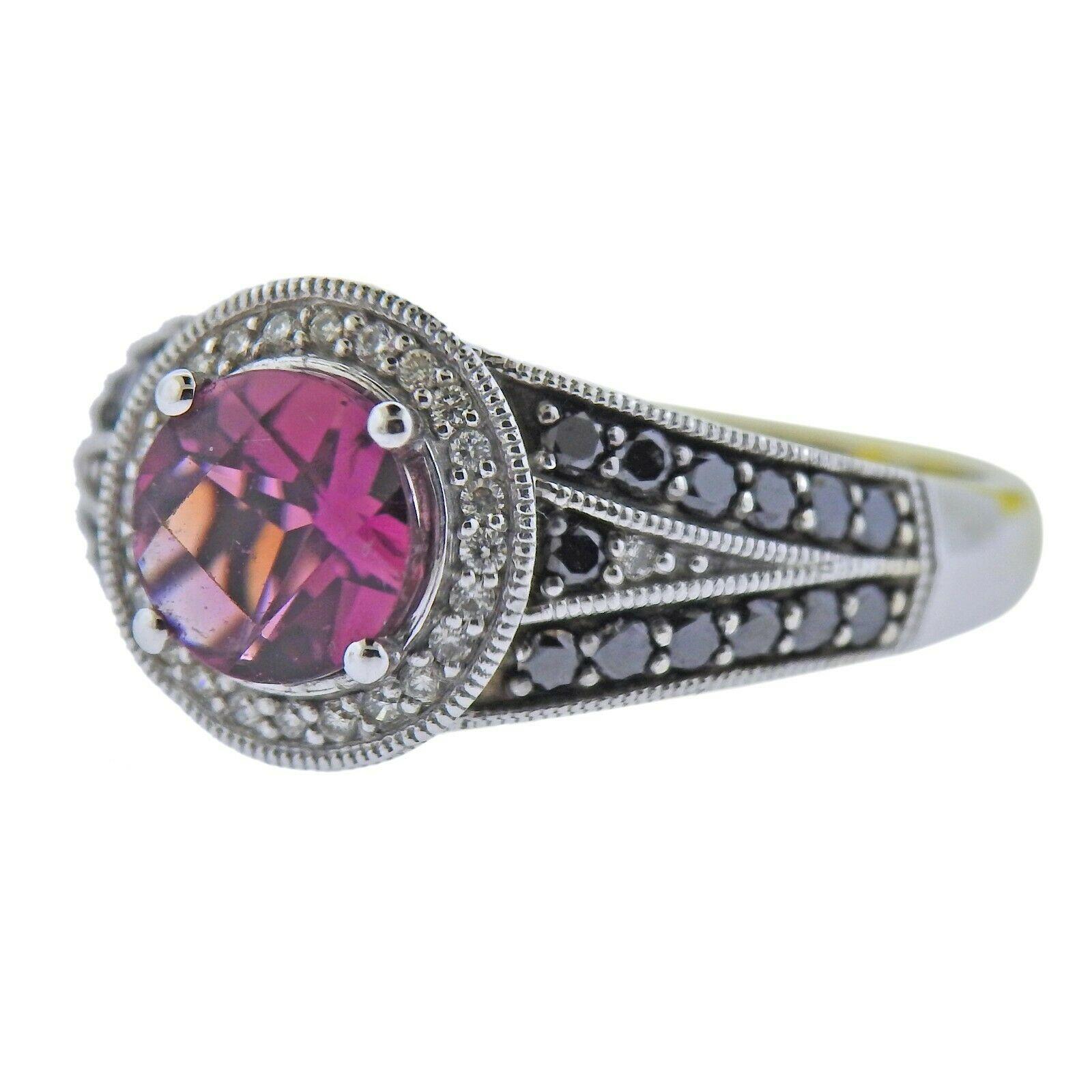14k white gold ring by LeVian. Set with a total 0.49ctw of SI1/H and black diamonds, and a 1.20ct pink tourmaline. Ring size - 6.75, ring top - 11mm wide. Marked - Arusha by Le Vian, 14kt. Weight- 4.9 grams.
