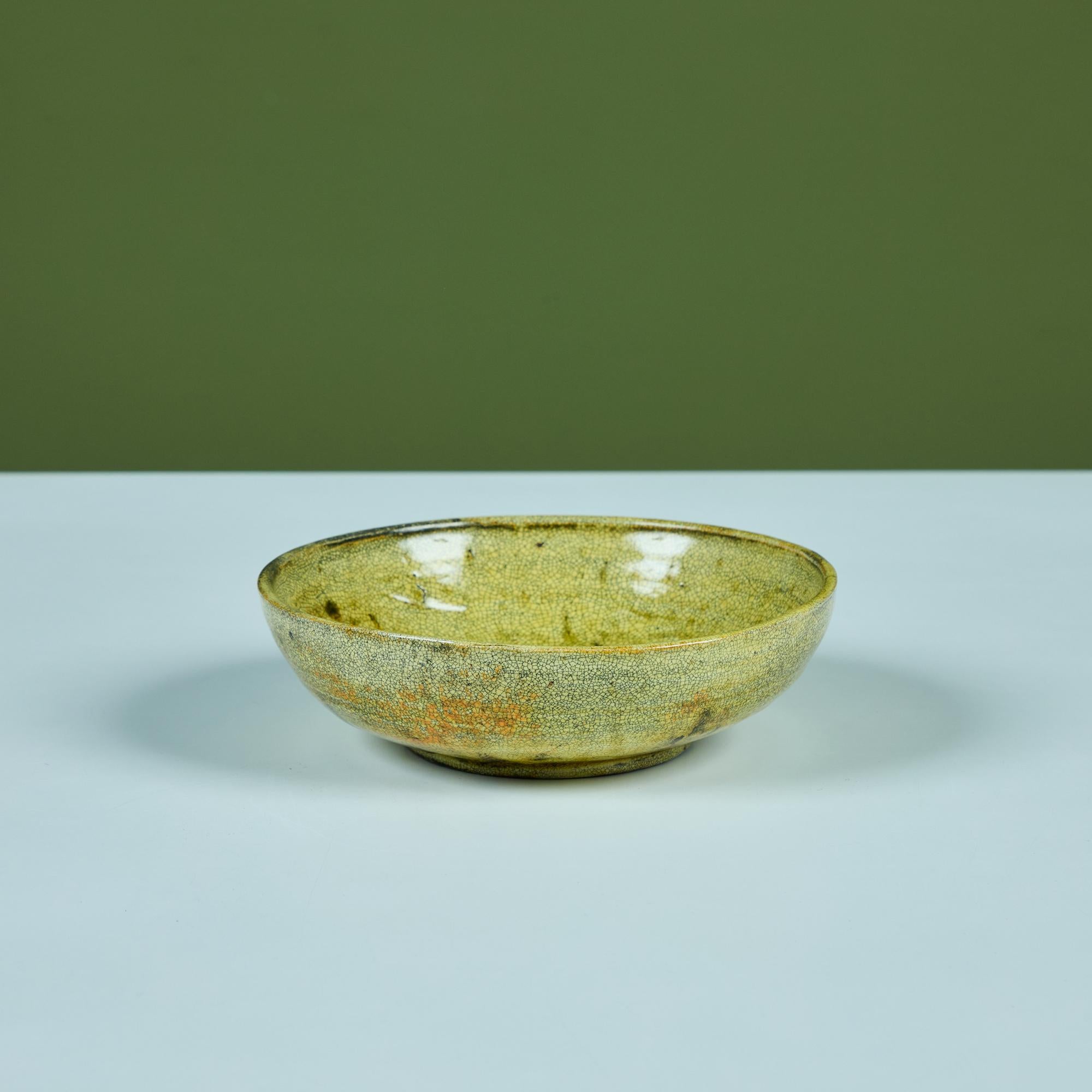 Ceramic glazed bowl by Polish born ceramicist, Lea Halpern. The bowl features an all over yellow glaze with speckles that darkens near the center of the bowl. Inscribed on the underside, “L. Halpern”

Dimensions
6.25
