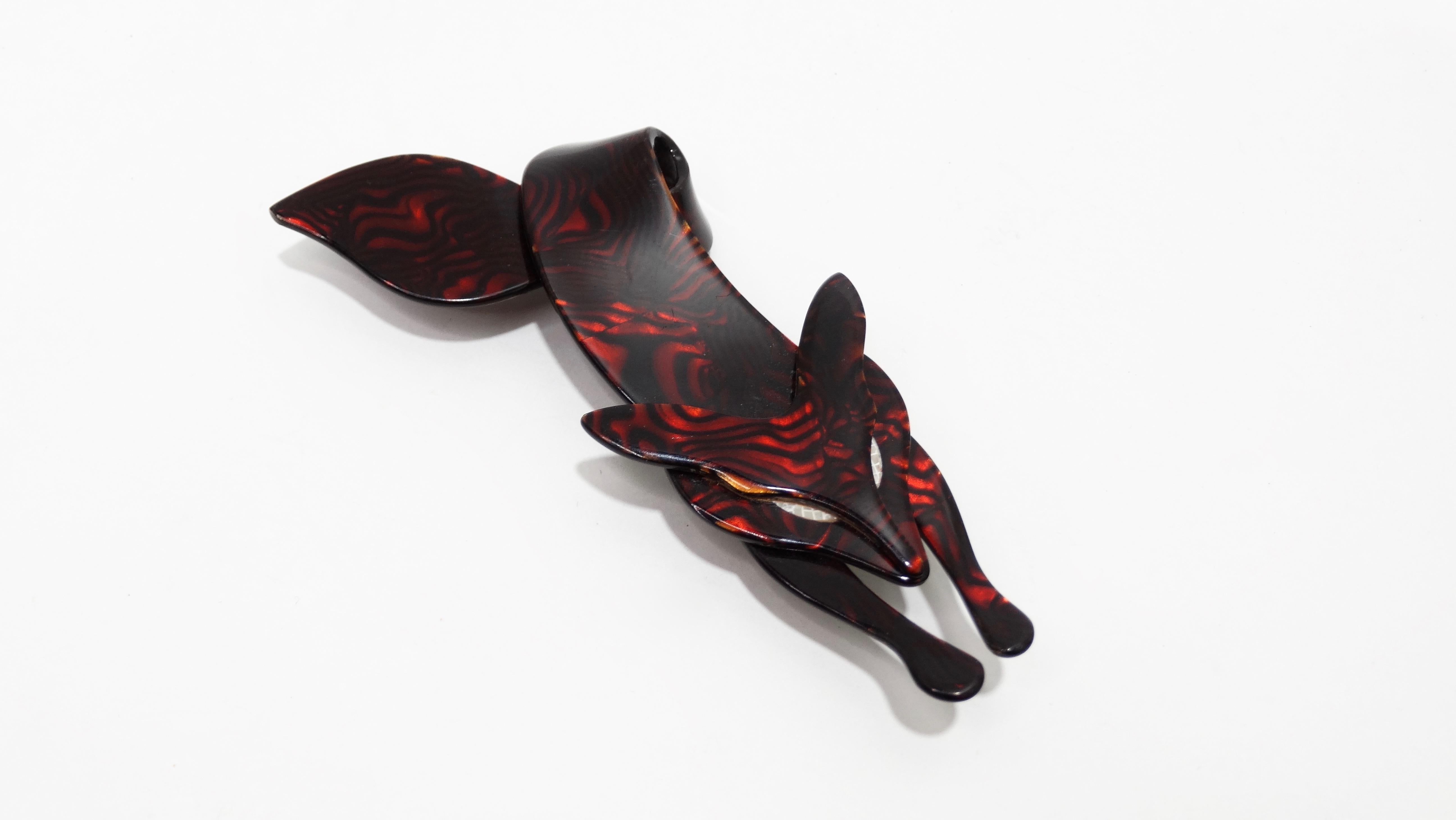 Are you the Foxiest of them all? Crafted from celluloid, this beautiful crawling fox brooch was designed by French artist Lea Stein and dates back to the late 1970's. Featuring a red and black asymmetrical swirl design with white eyes, this brooch