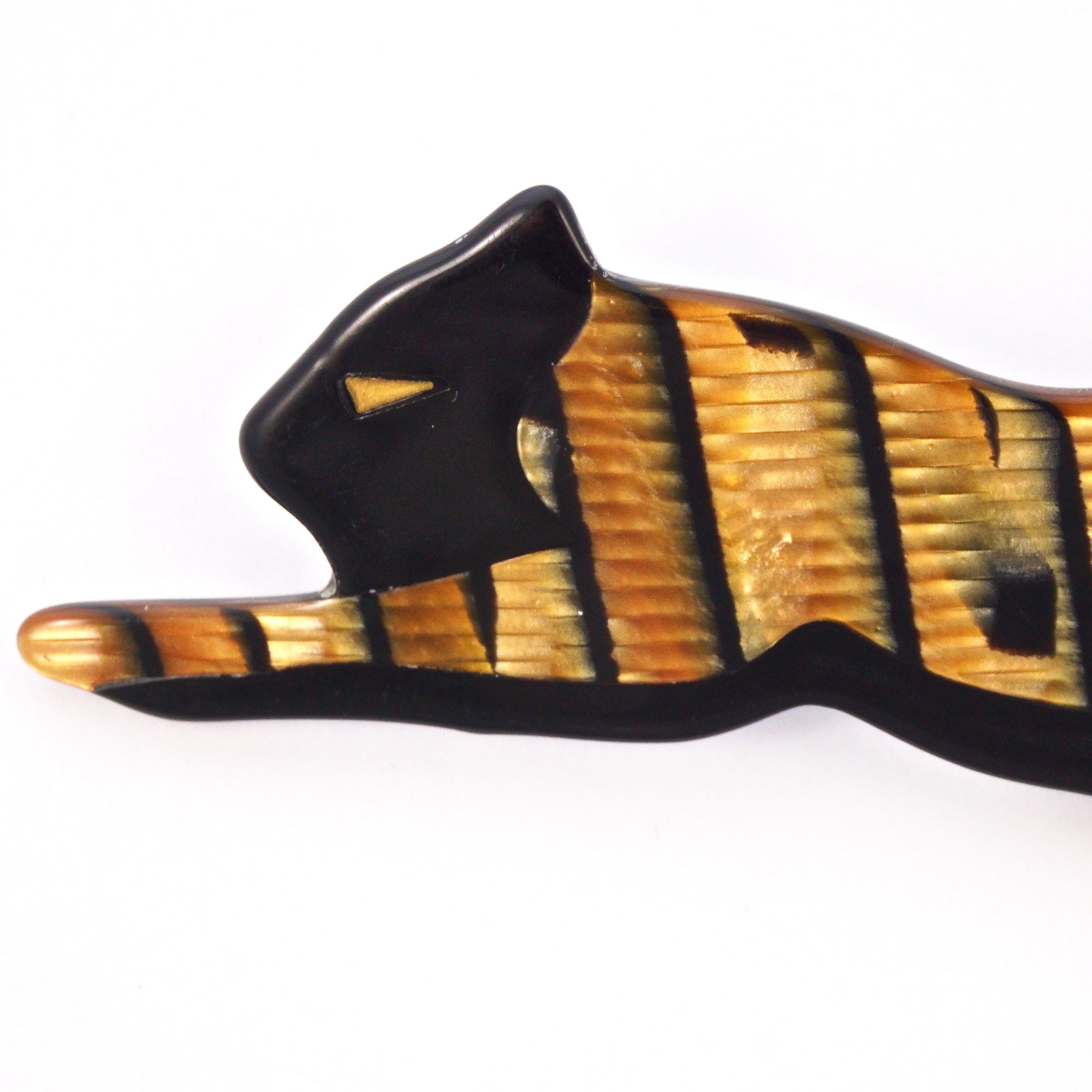 Lea Stein panther brooch in a wonderful iridescent gold and black design. The brooch is made from layered plastic, and measures approximately length 10.5cm / 4.1 inches by width 3.5cm / 1.37 inches.

This is a beautiful collectable iridescent gold