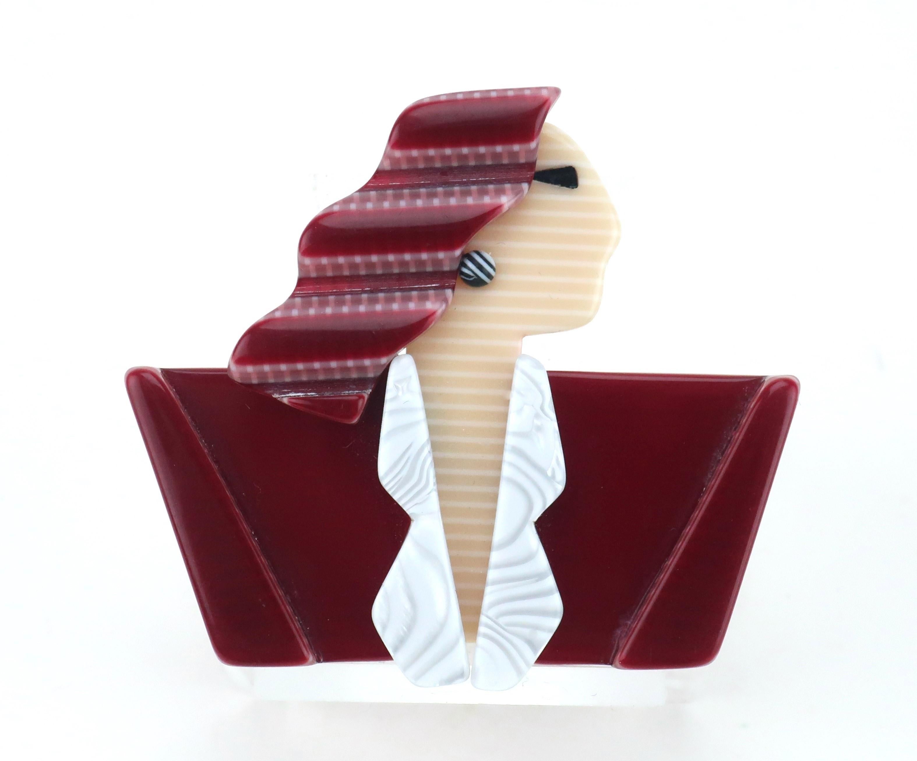 1970’s Lea Stein plastic brooch depicting Hollywood icon, Joan Crawford … shoulder pads and all!  French designer, Lea Stein, has often been recognized for her unique designs and particularly the method she perfected of layering Rhodoid to create a