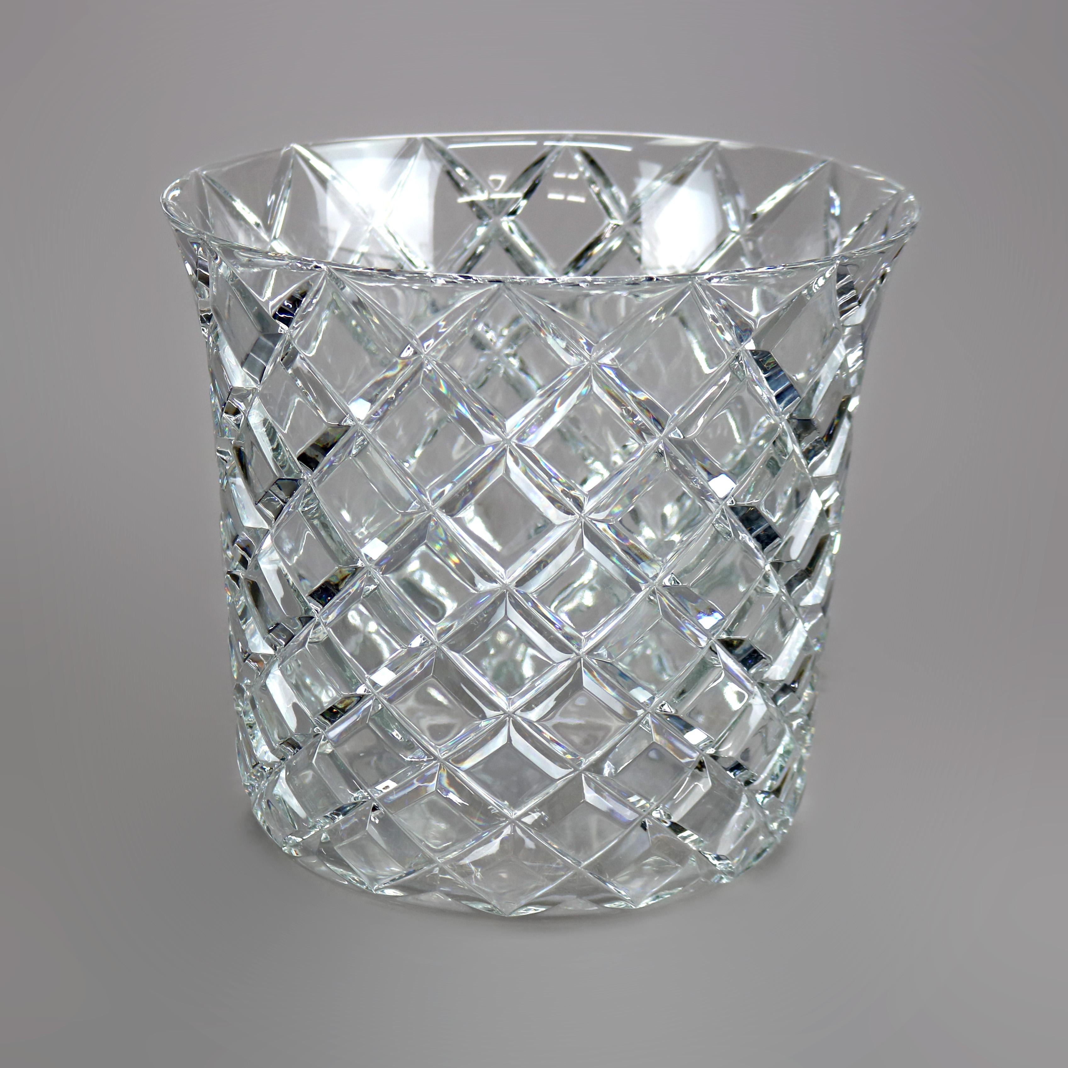 A champagne bucket in the manner of Tiffany & Co. offers lead crystal construction with diamond pattern, maker signed, 20th century

Measures - 8.5'' H x 9.25'' W x 9.25'' D.

Catalogue Note: Ask about DISCOUNTED DELIVERY RATES available to most