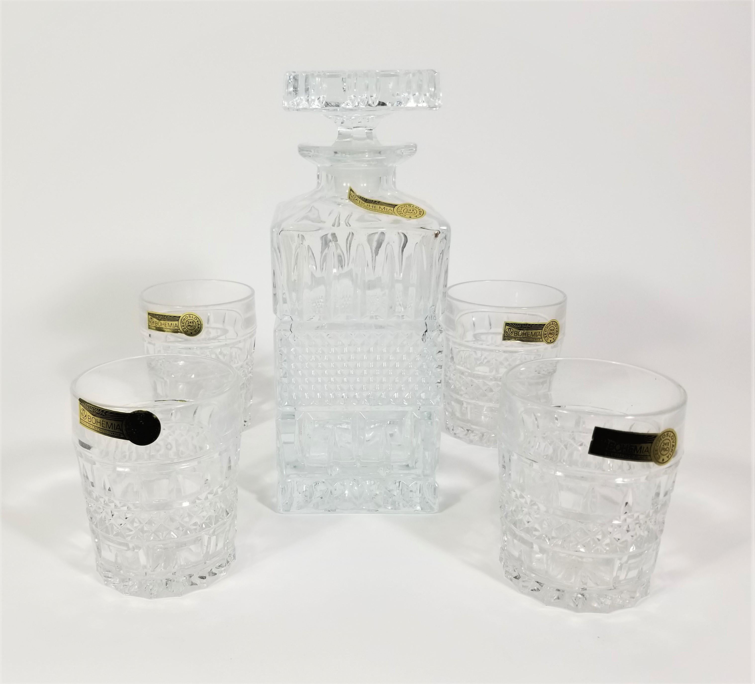 Mid Century 1960s Crystal Barware Glassware Set by Bohemia Crystal, Czechoslovakia. Unused with Tags. Set includes 1 Decanter and 4 matching rocks style glasses. All pieces are unused and retain original marking stickers. 24% PbO Lead Crystal. An