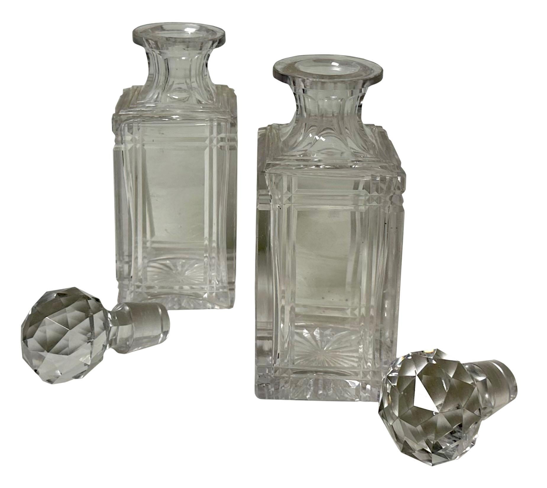 A pair of late 19th century English lead crystal perfume bottles beautifully cut and faceted. 
