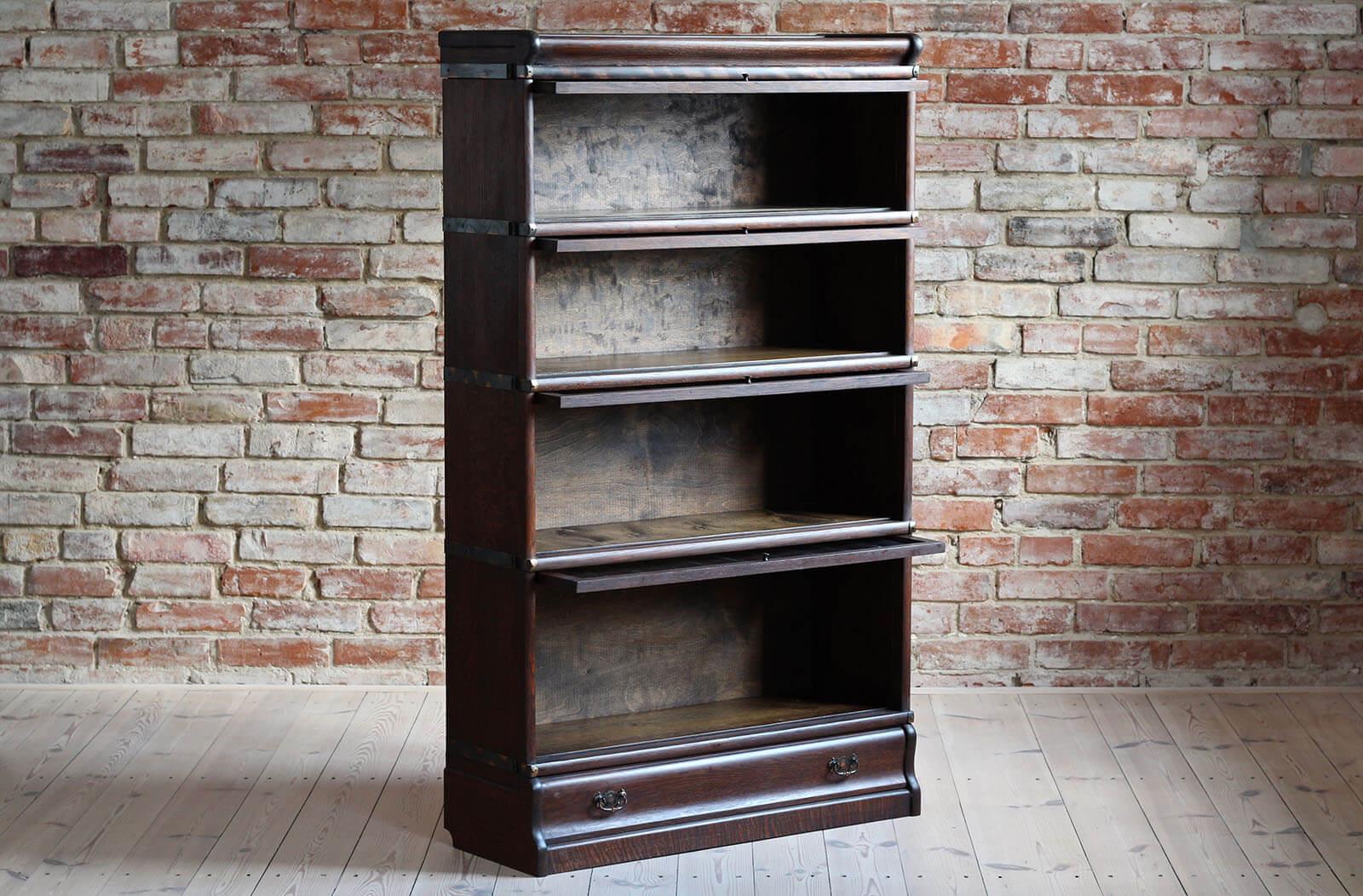 Rare barrister bookcase with beautiful and unique lead glass. The piece features 4 stacking bookcases of different sizes that allow to store books or items of different heights. It is made of solid oak wood around early 20th century. In the lower