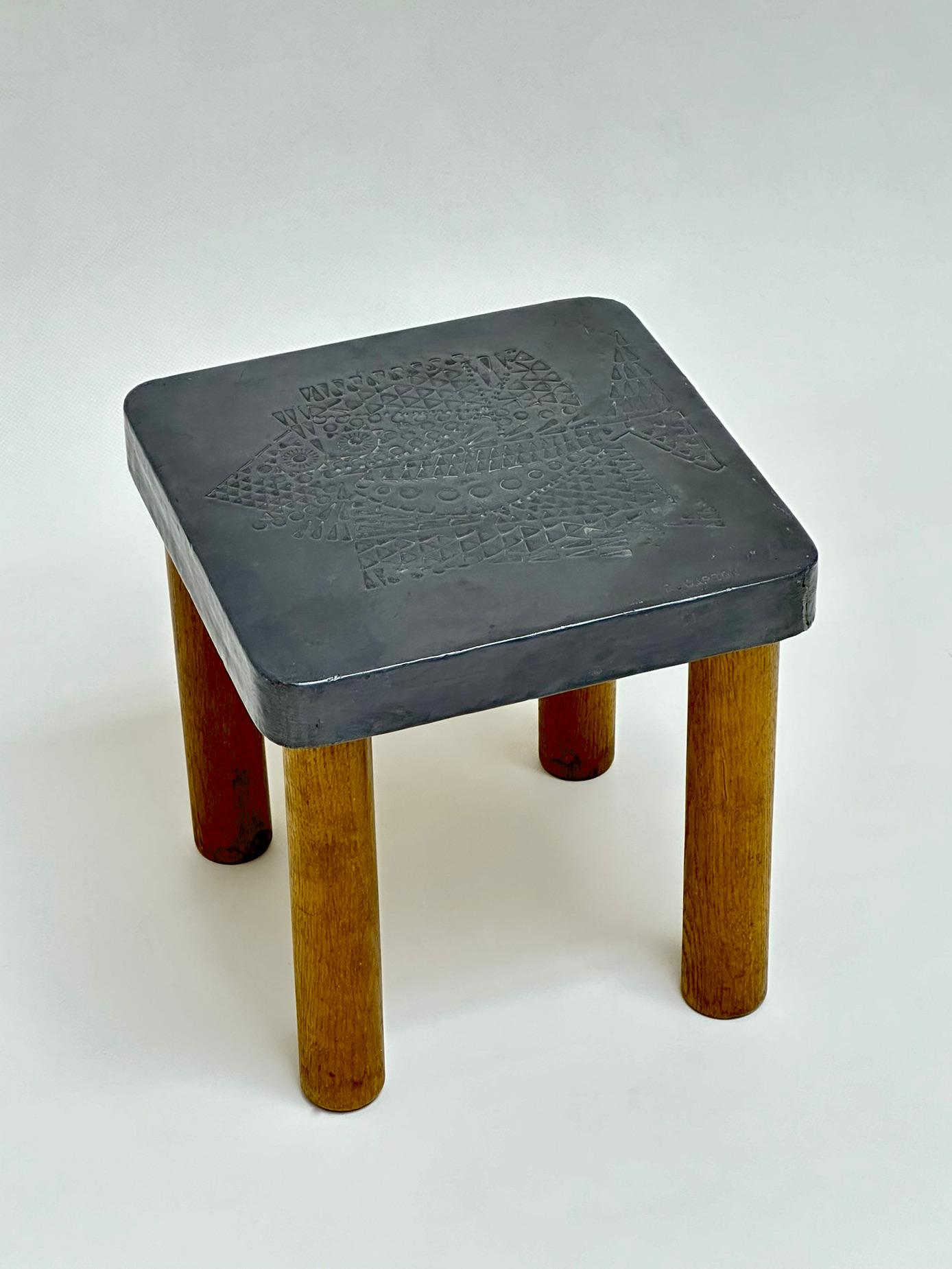 Table top consisted of an embossed lead foil stretched over a wooden frame fixed on 4 tubular oak legs.

An exceptional cooperation with Jean Derval for this atypical hand crafted work which found a special application for the decorative elements of