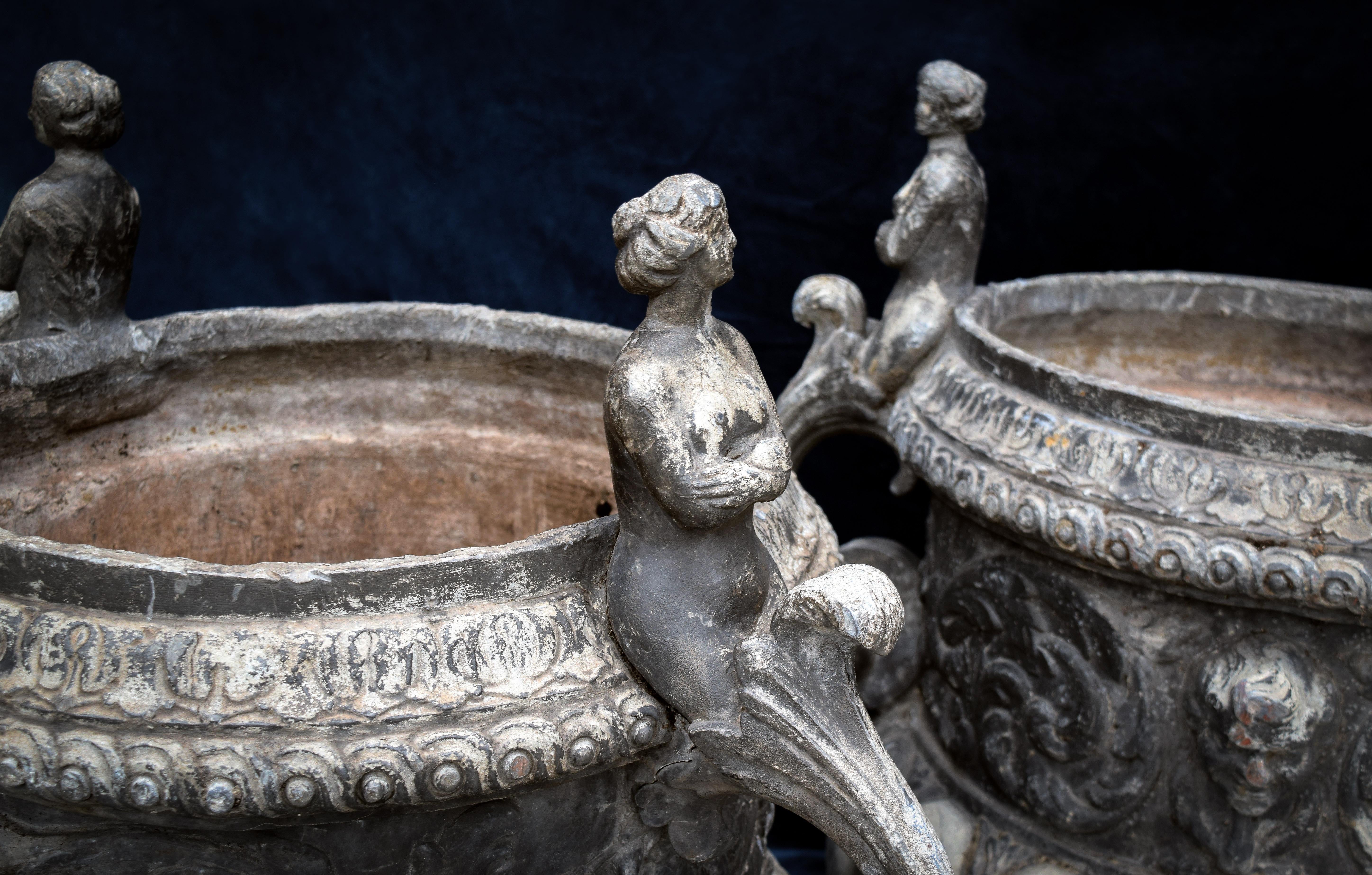 Fleurdetroit is delighted to offer for your consideration this exceptional pair of lead urns. 

A stark statement of function and form, this pair of vintage English lead urns is an arresting archetype of 18th century aesthetic. Purchased from a