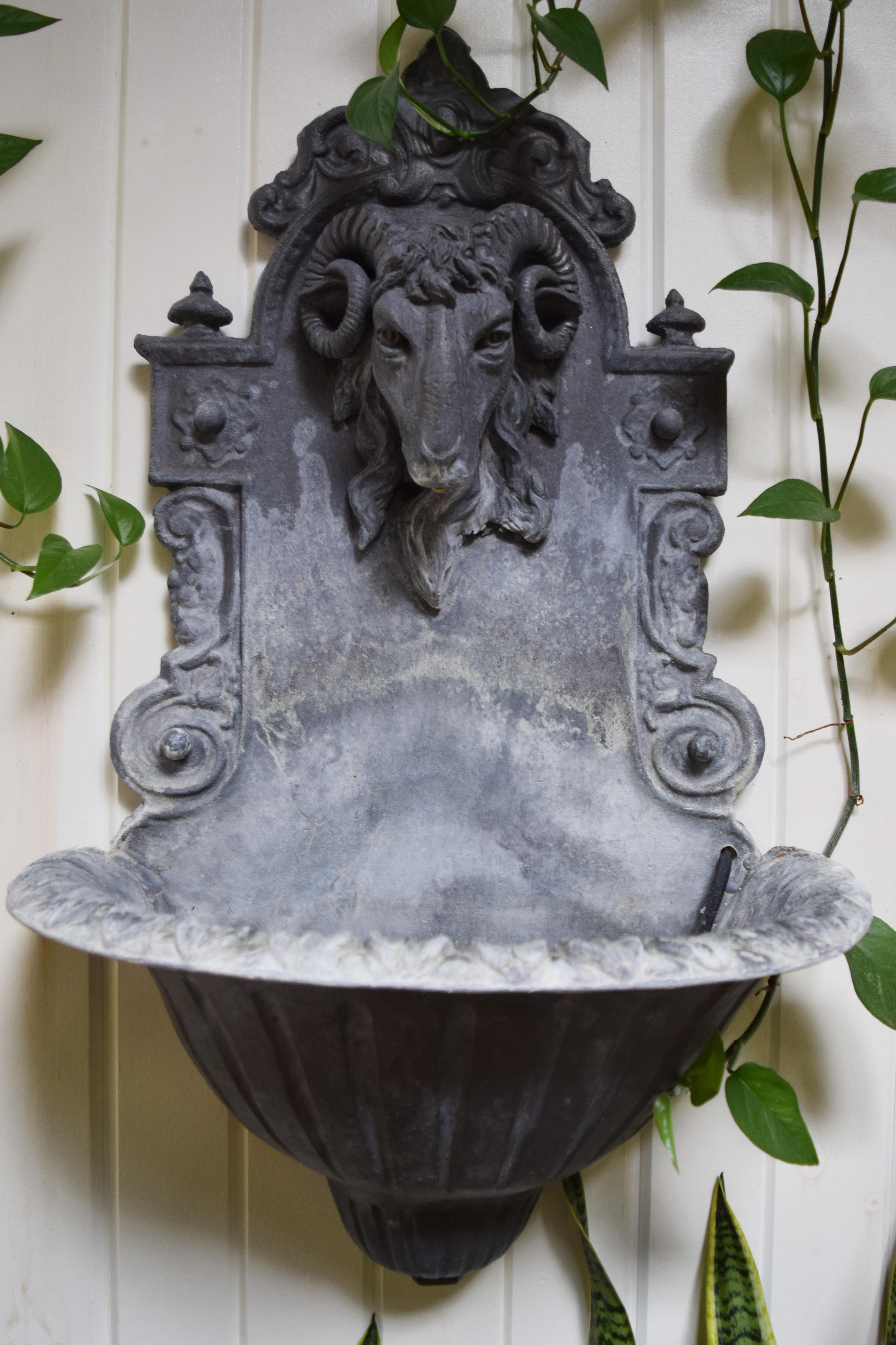 A modern take on a classic art form, Stephen Markham’s techniques transcends the time-honored craft of lead work into a contemporary landscape. 

This ornate, wall-mount fountain features a stately rams head and scrollwork entirely cast in British