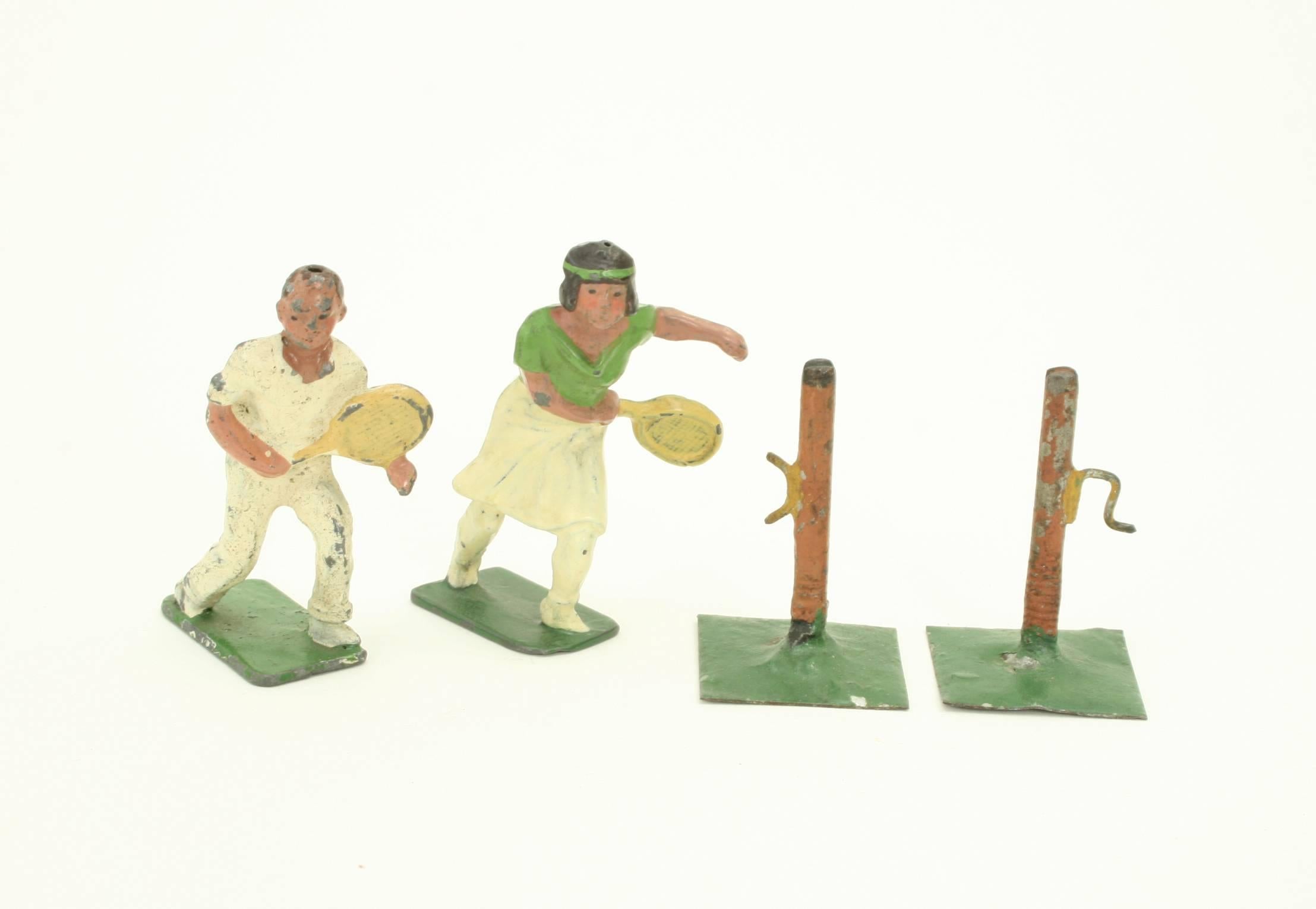 An unusual and rare set of lead tennis figures made by Johillco.
The set comprises of a male and female tennis player, in action poses holding tennis rackets, and is complete with net posts. The figures are all original with minor chipping