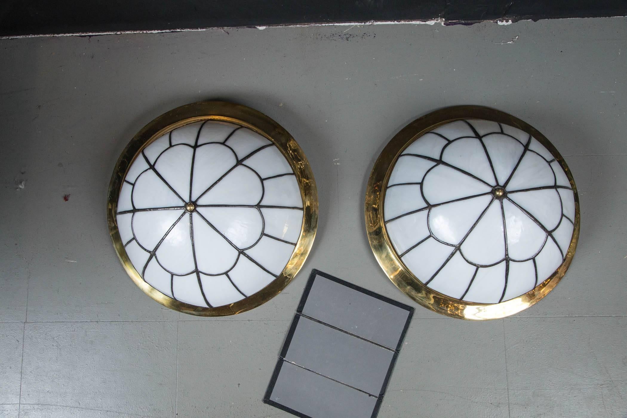 A set of 24 circa 1920s leaded glass flush mounted light fixtures with interior lights. 24 available; $4,800 per fixture.