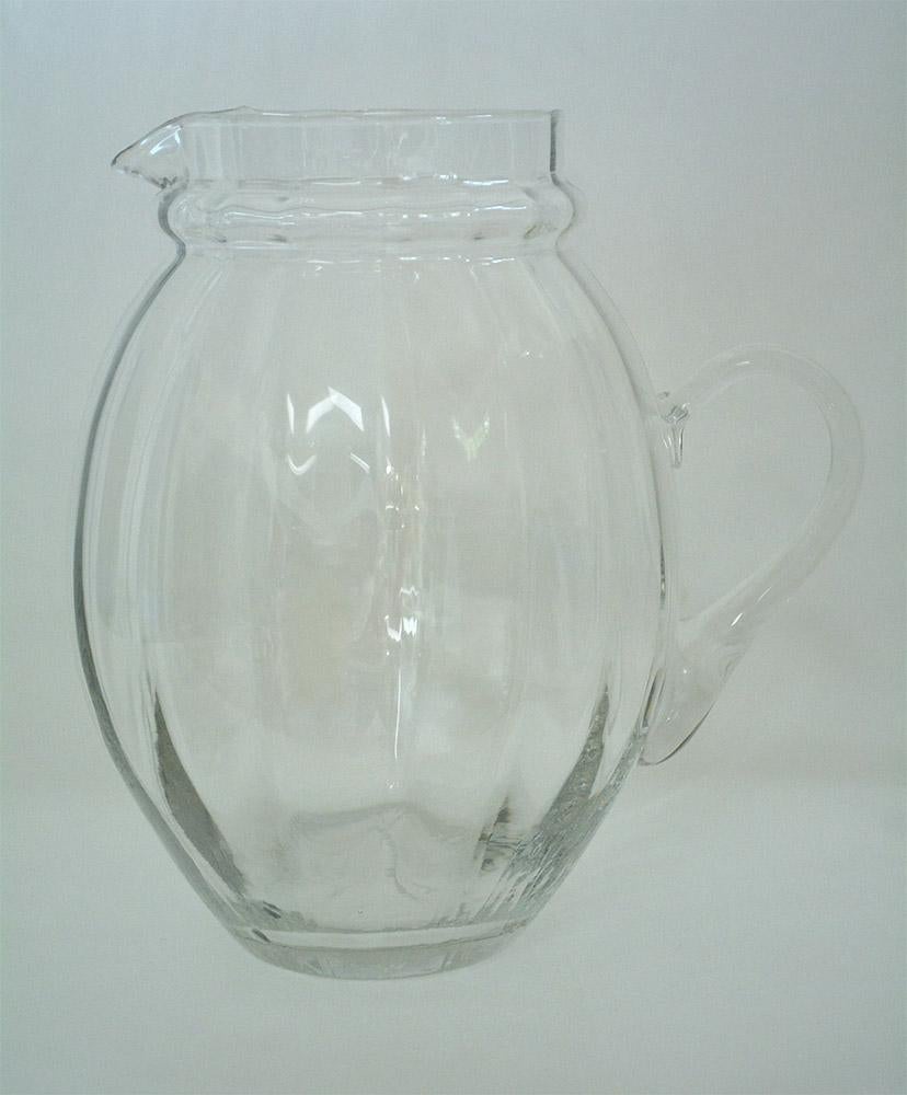 Large Italian mellon shaped glass water pitcher. Use it for serving water, wine or punch. This pitcher has an elegant vertically fluted baluster shape with a good open top and pouring spout, with a loop handle all as in the late Georgian style. The