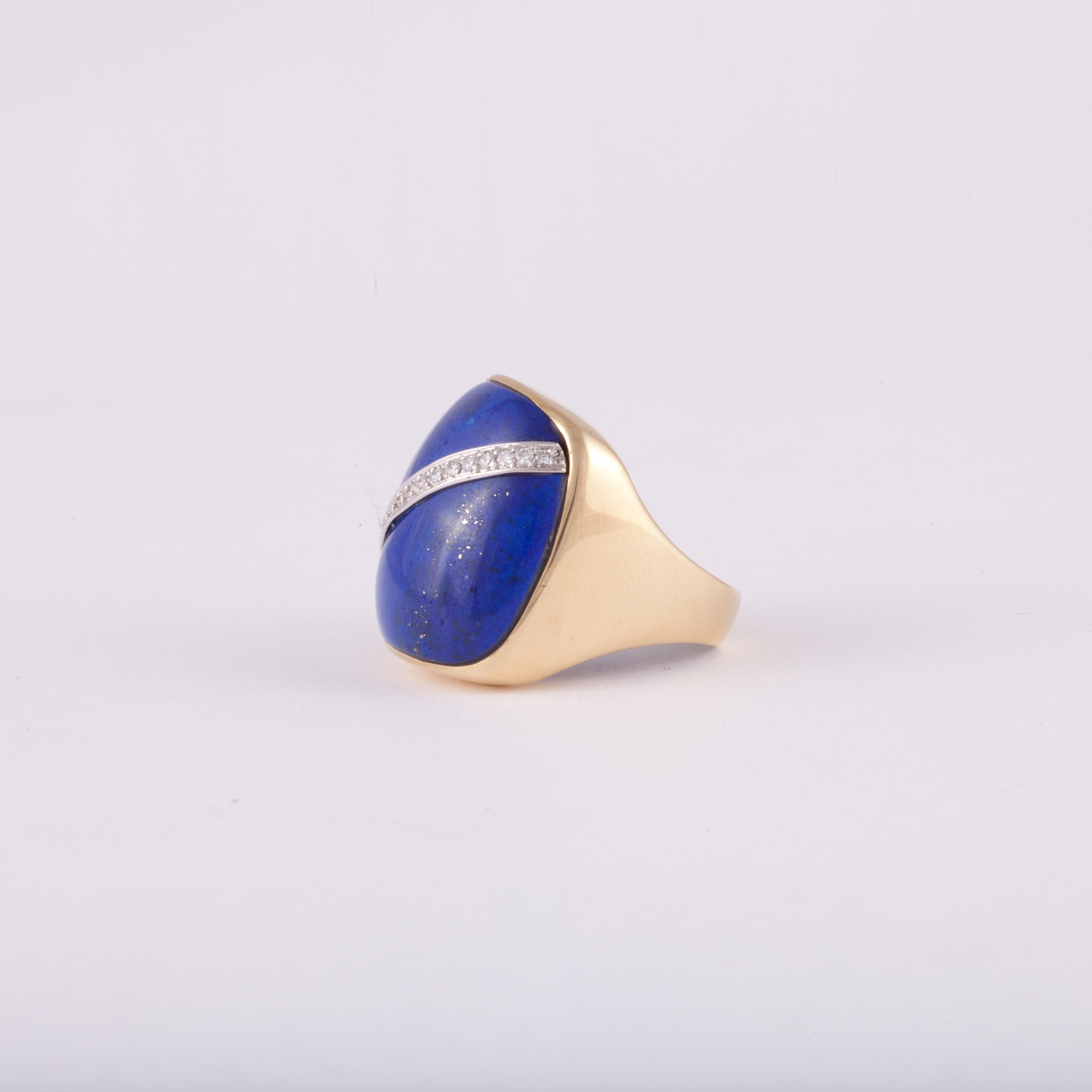 Ring composed of 18K yellow gold featuring lapis lazuli accented by round diamonds.  The ring is marked 