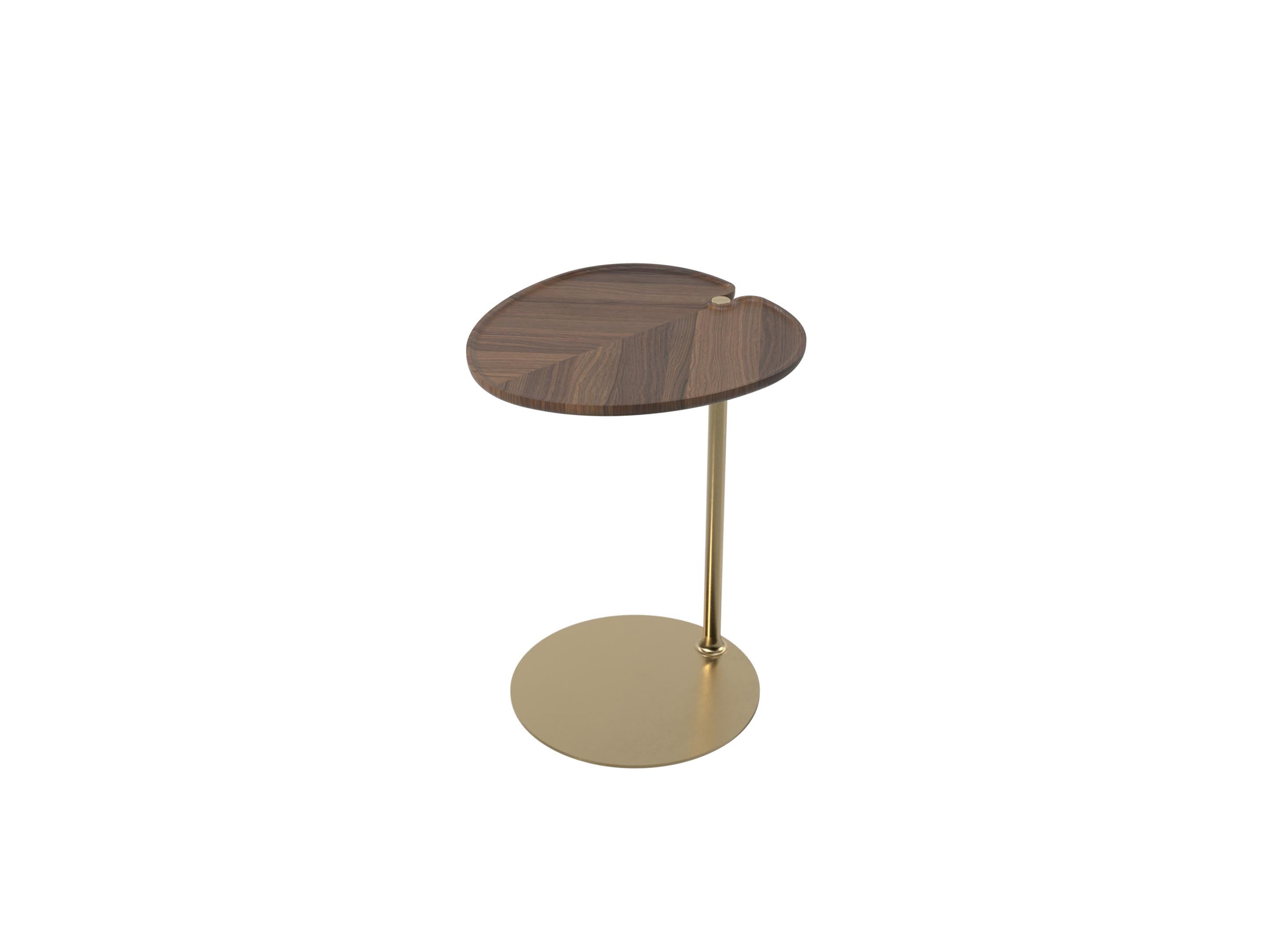 Leaf 1 oval side table by Mathias De Ferm.
Dimensions: D 42 x W 40 x H 55.5 cm.
Materials: Walnut wood, brass.
Also available in different materials. 
 
LEAF-shaped walnut/oak tabletops revolve around a sleek brass base with a carefully crafted