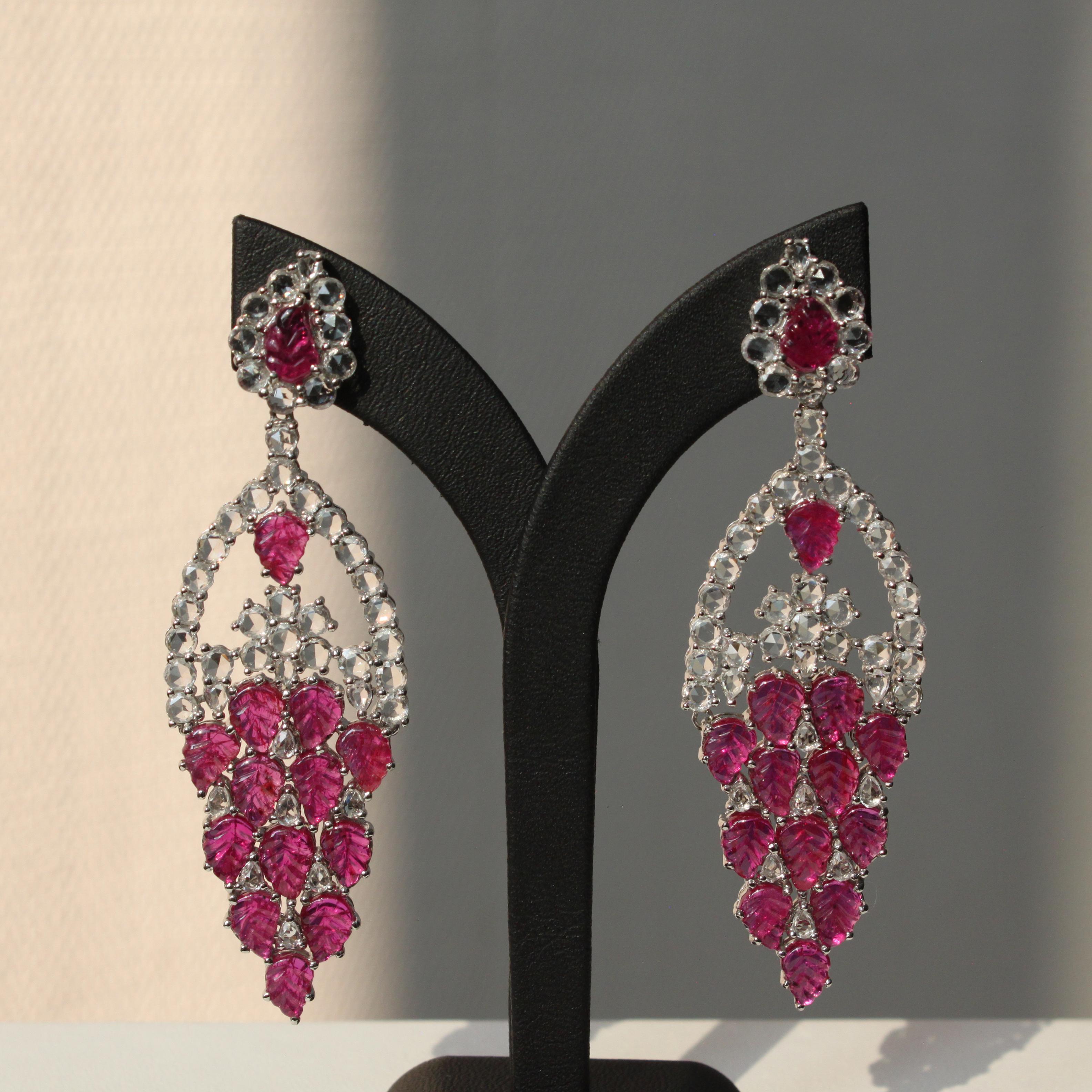 14K white gold
15.39 ct ruby
8.59 ct white sapphire
Total earring weight 23.50g

These captivating earrings combine the beauty of natural elements with timeless design. The earrings feature unique leaf-carved rubies, weighing approximately 15.39