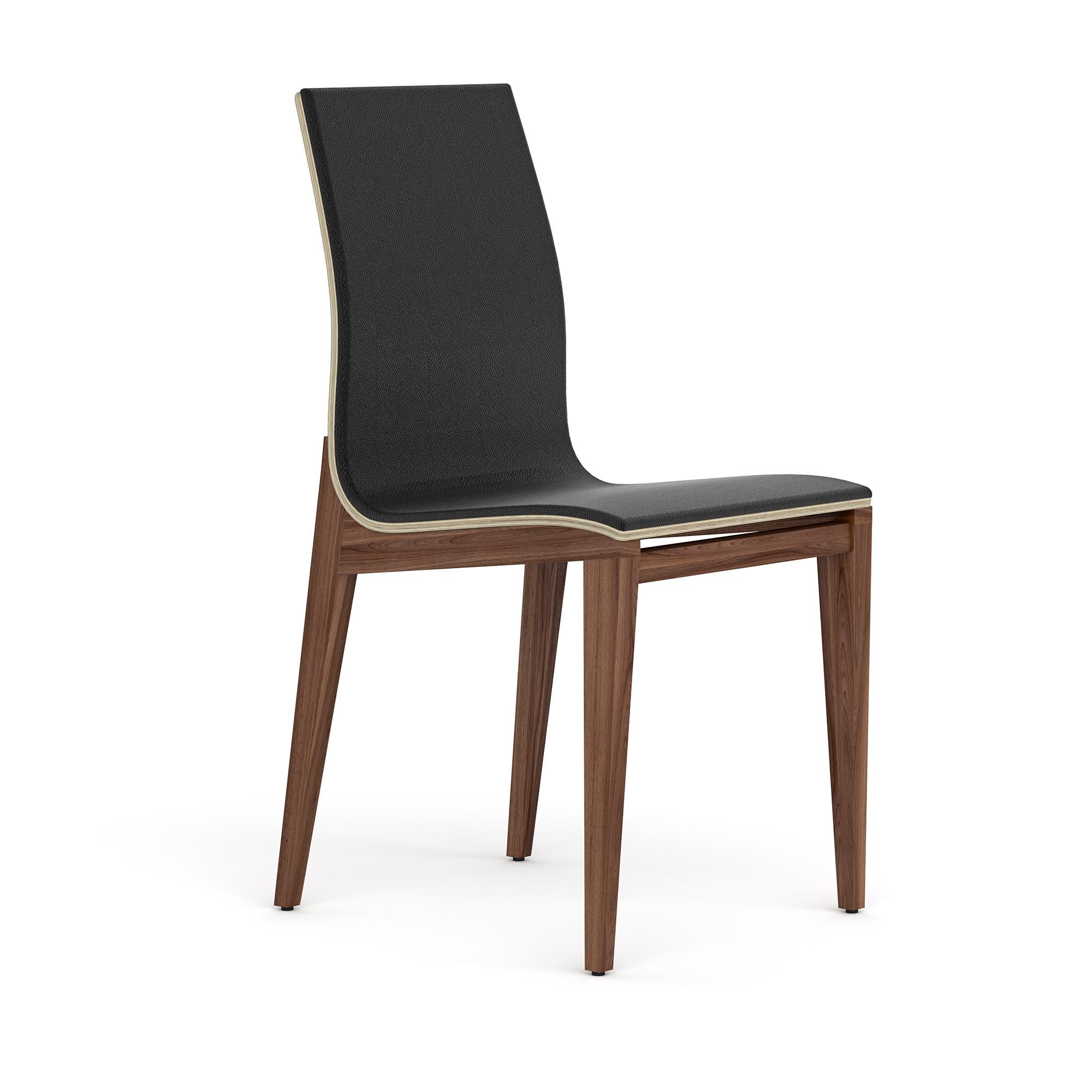 At first glance it appears to be a simple wood dining chair. And it is. A well-built, simple lined yet elegant and comfortable chair, that can complete a dining room without imposing itself. It is only when seeing its profile that one can admire its