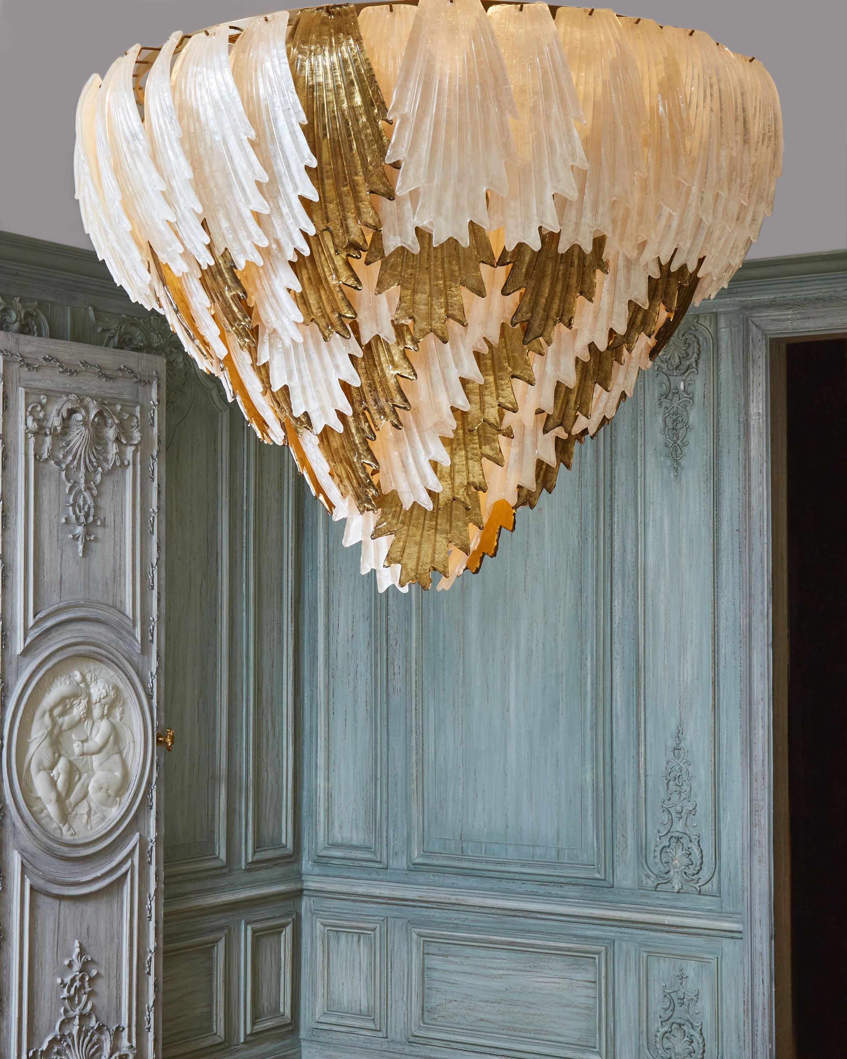 Brass chandelier with sculpted and gilt Murano glass with gold leaf.
Creation by Studio Glustin.