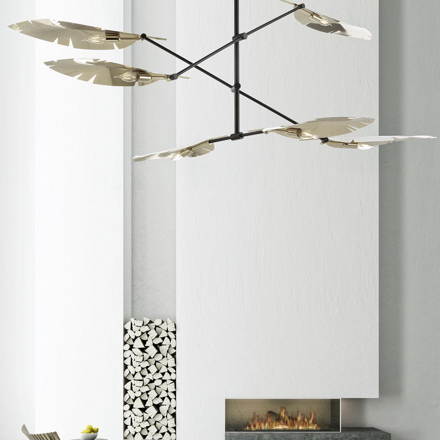 A stylish take on the playful mobile design, this nature-inspired chandelier features three slender linear bars mounted on a central pole, holding two leaf-shaped shades at each end. The matte black metal frame complements the pale gold finish of