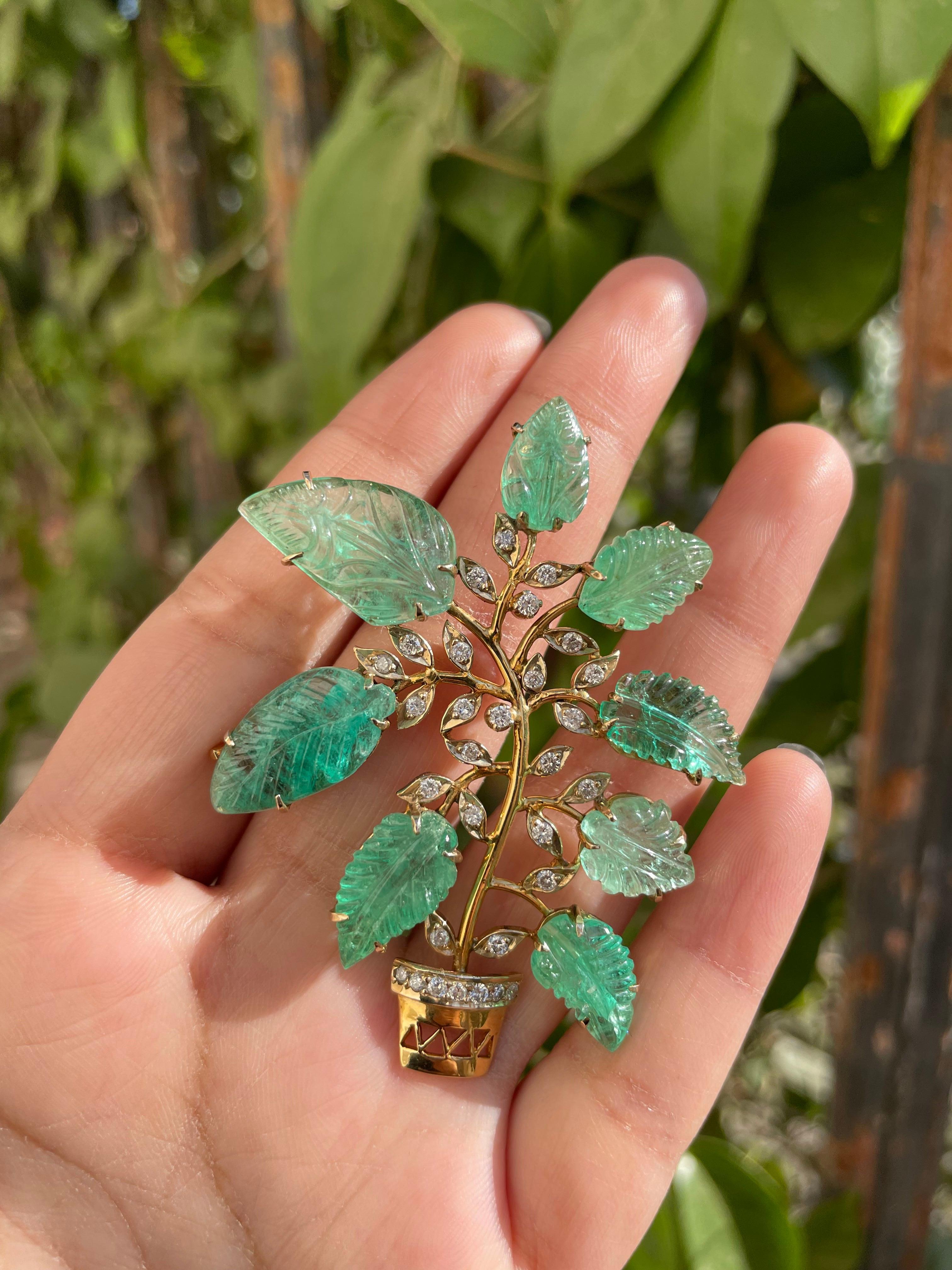 Carved Emerald Diamond Flower Pot Brooch Made in 18k Gold which is a fusion of surrealism and pop-art, designed to make a bold statement. Crafted with love and attention to detail, this features 30 carats of emerald which makes you stand out of the