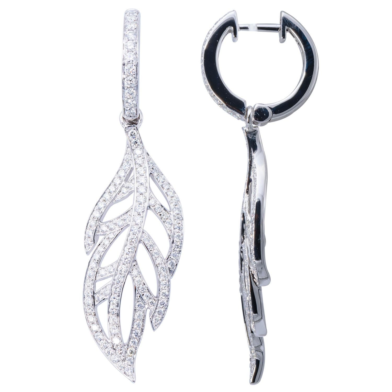 Perfect for fall or all year round these leaf shaped dangling earrings are a unique and beautiful accessory. These gorgeous leaves are made from 226 VS2, G color diamonds that are expertly set in 7.7 grams of 18 karat white gold. They hang from a
