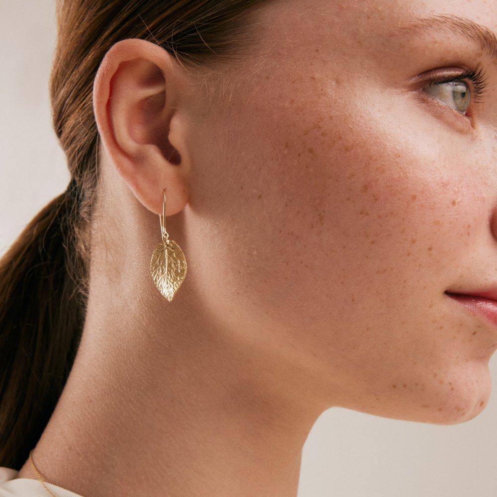 Introducing the 14K Solid Gold Hammered Leaf Earrings from Orena Jewelry, where each piece is a celebration of nature's unique artistry and Orena's exceptional craftsmanship. These earrings are hand-finished with a hammered texture, ensuring that