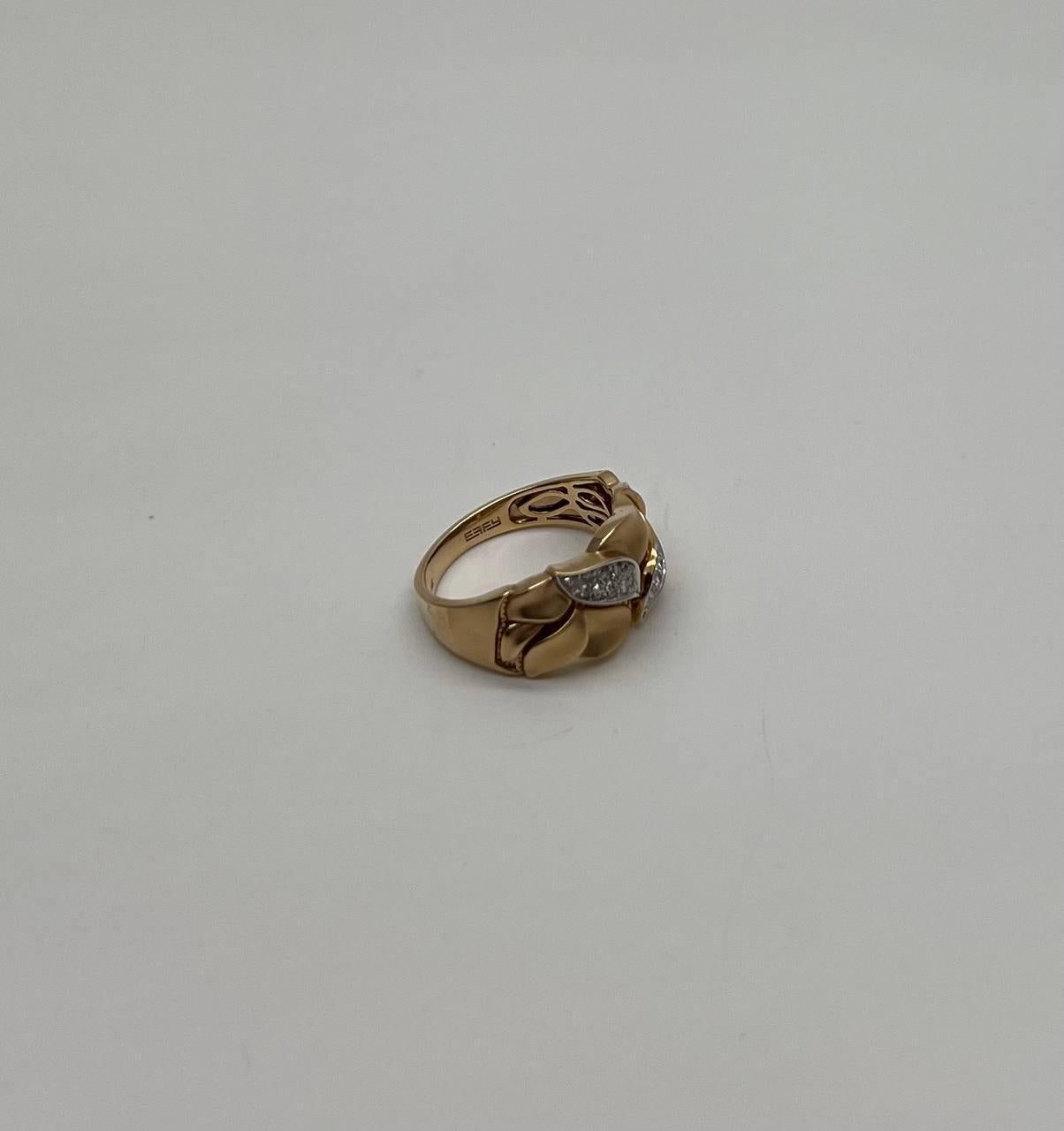 This contemporary ring features a unique design with several leaf-like motifs adorned with sparkling diamonds. The leaves are elegantly set against a smooth gold band, creating a striking contrast. 14K Yellow Gold. 0.15 CTW Diamonds