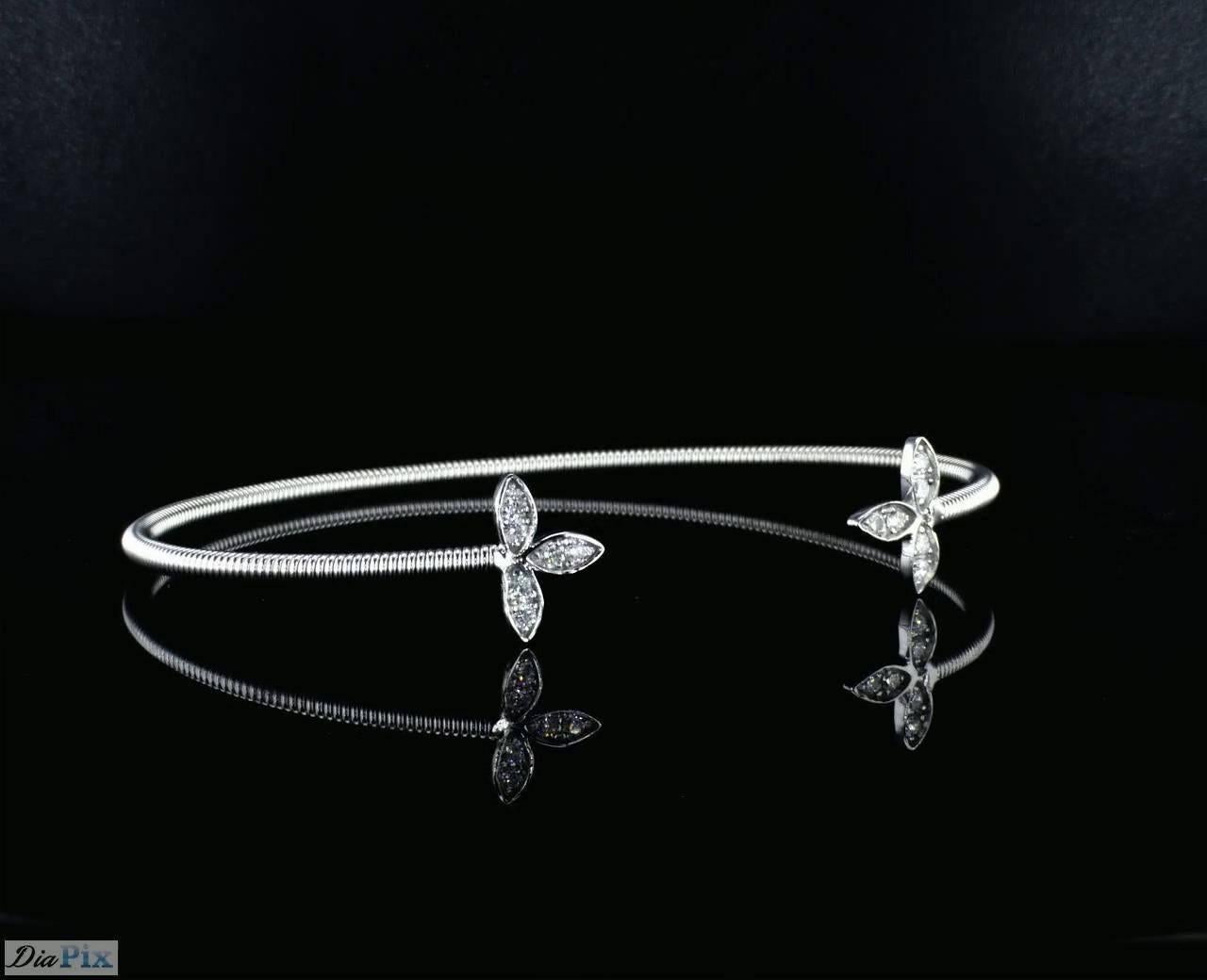 Flexible 14K White Gold spring bangle bracelet with diamonds on the sides. Each side of the classic bracelet has a leaf motif shape and is set with diamonds. 

Side diamonds- 12 diamonds round brilliant cut , 0.20 Carat total diamond weight ,  G-I /