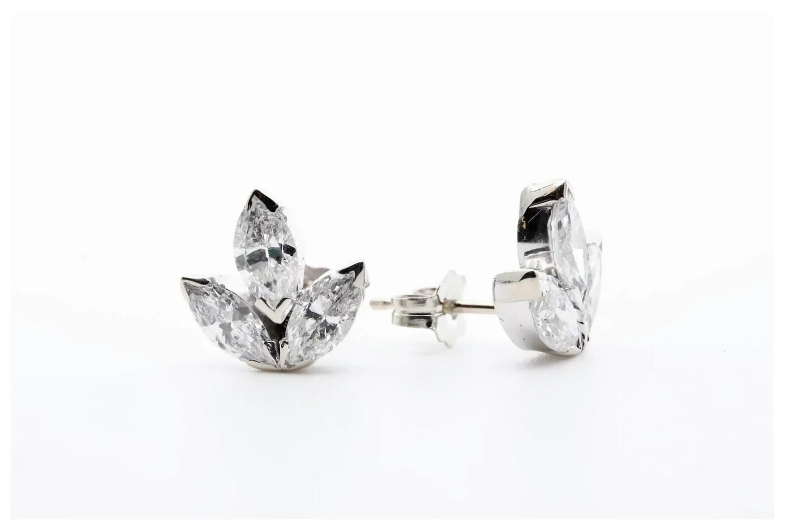 A pair of mid century three pointed leaf shaped diamond studs set in 14 karat white gold. Each set with a 0.25 carat marquise shaped diamond weighing a combined 1.50ctw. The diamonds grade as H color, VS2 clarity.

Earrings measure 10mm in height