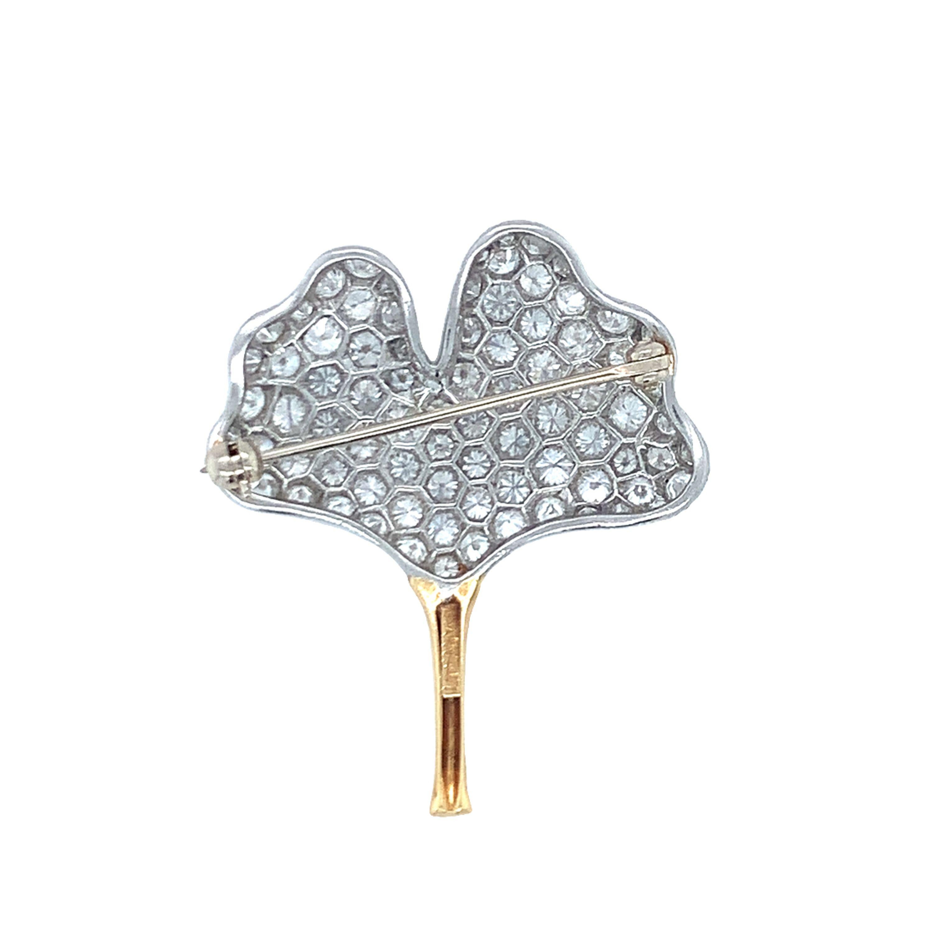One gingko leaf motif diamond pin in platinum and 18k yellow gold by Tiffany & Co. featuring 80 pave set, round brilliant cut diamonds totaling 4.42 ct. with F color and VVS-1 clarity. Accompanied by power blue Tiffany & Co. pouch.

Enchanting,