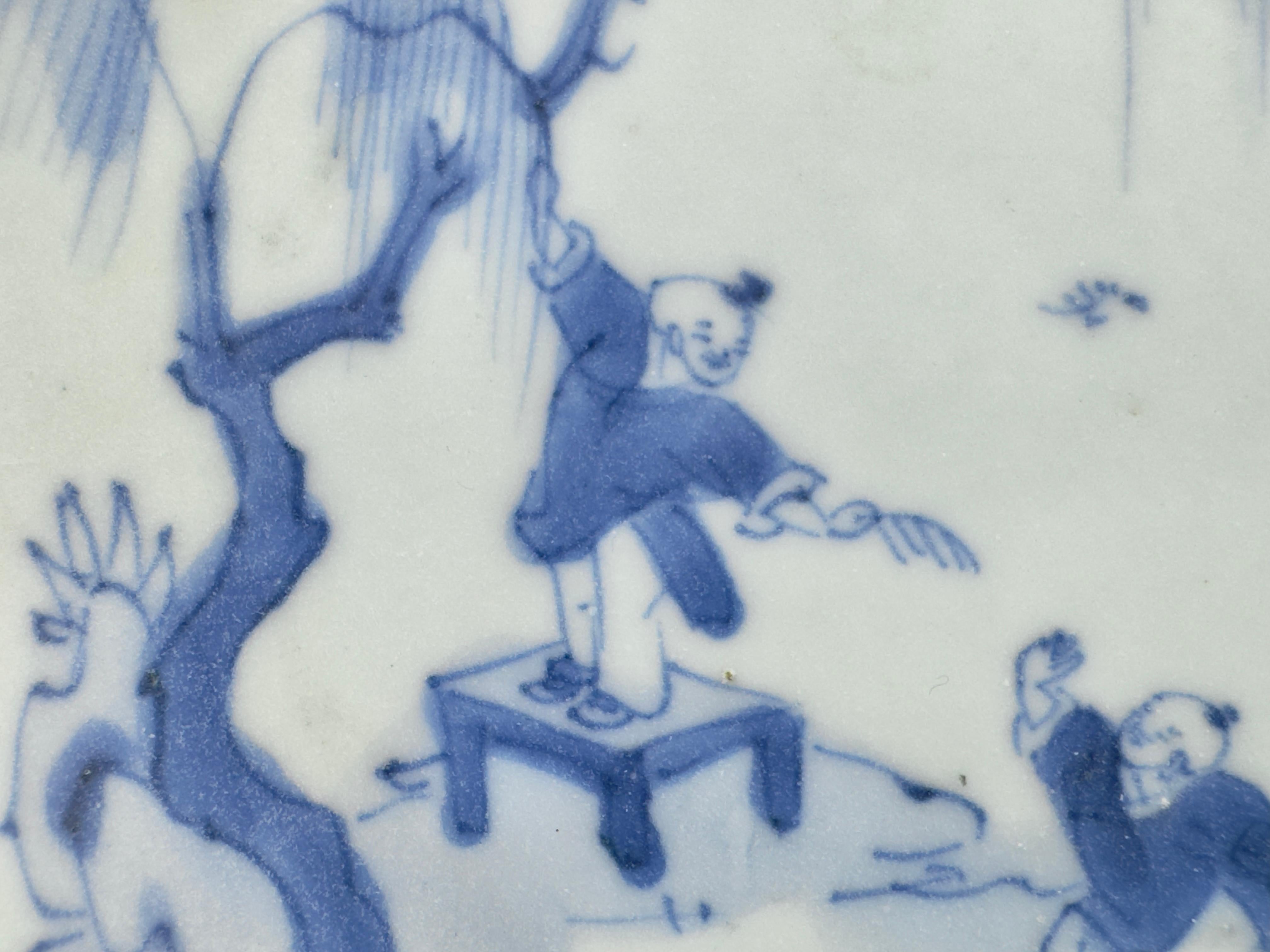 The ceramic portrays a tranquil scene set against a backdrop typical of the Shan Shui tradition, which emphasizes the symbiotic relationship between humans and nature. In the center of the composition, a figure stands upright on a raised platform