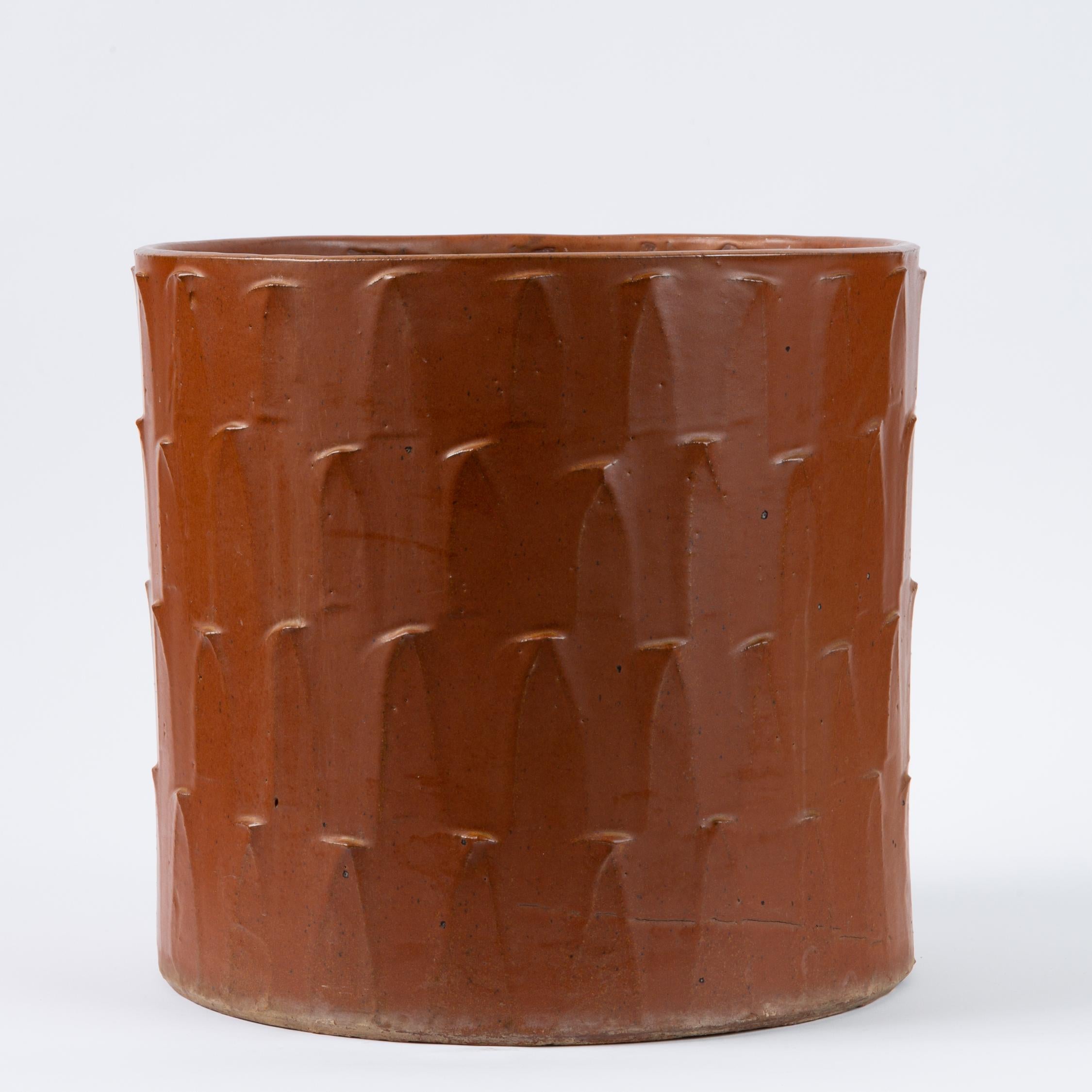 Model no. 4043 planter by David Cressey for Architectural Pottery’s Pro/Artisan stoneware line. The straight-sided cylindrical vessel is slip cast and then textured with the line’s “Leaf” option, a series of petal-shaped strokes moving up the sides