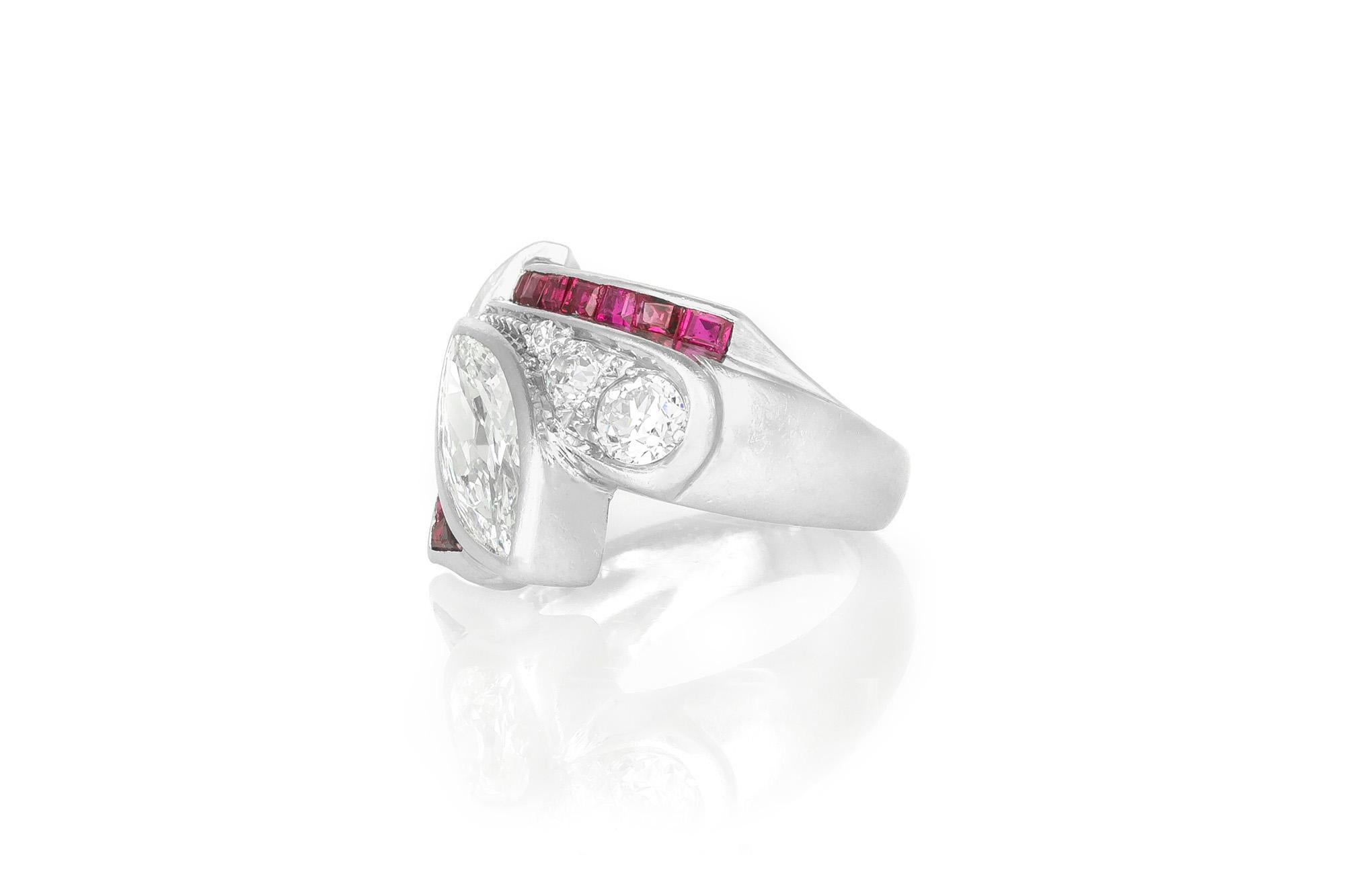 Finely crafted in platinum with a center marquise cut diamond weighing 1.25 carats.
The ring features 1.20 carats of square cut rubies and 0.50 carats of round brilliant cut diamonds.
Size 4, resizable
