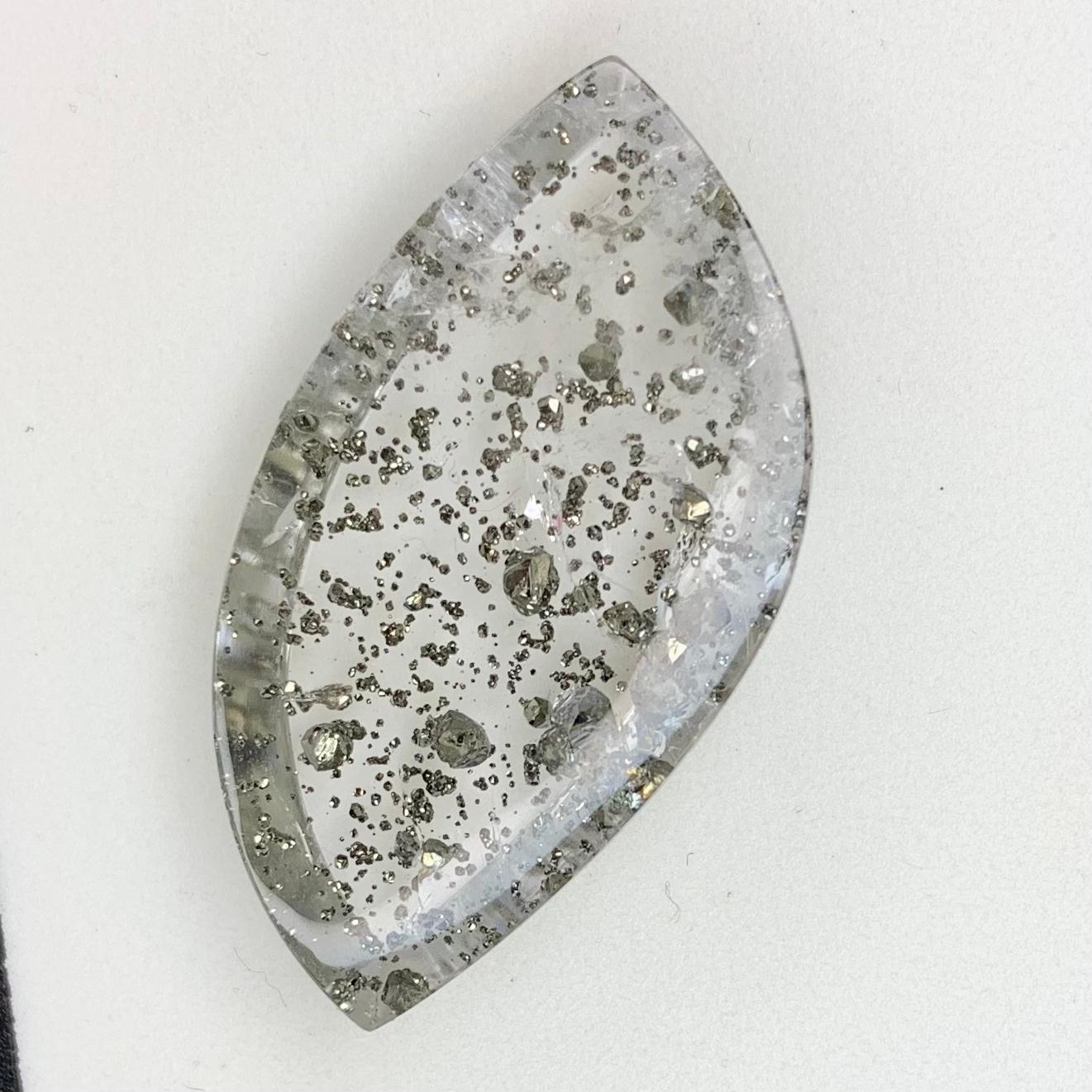 Meet Galaxy! 
A sliver of crystalized space is captured in this spectacular pyrite in quartz gemstone. This amazing piece of quartz was selected from a wonderful vendor (93-year-old Max Davis in California) for it's unique pyrite inclusions, which