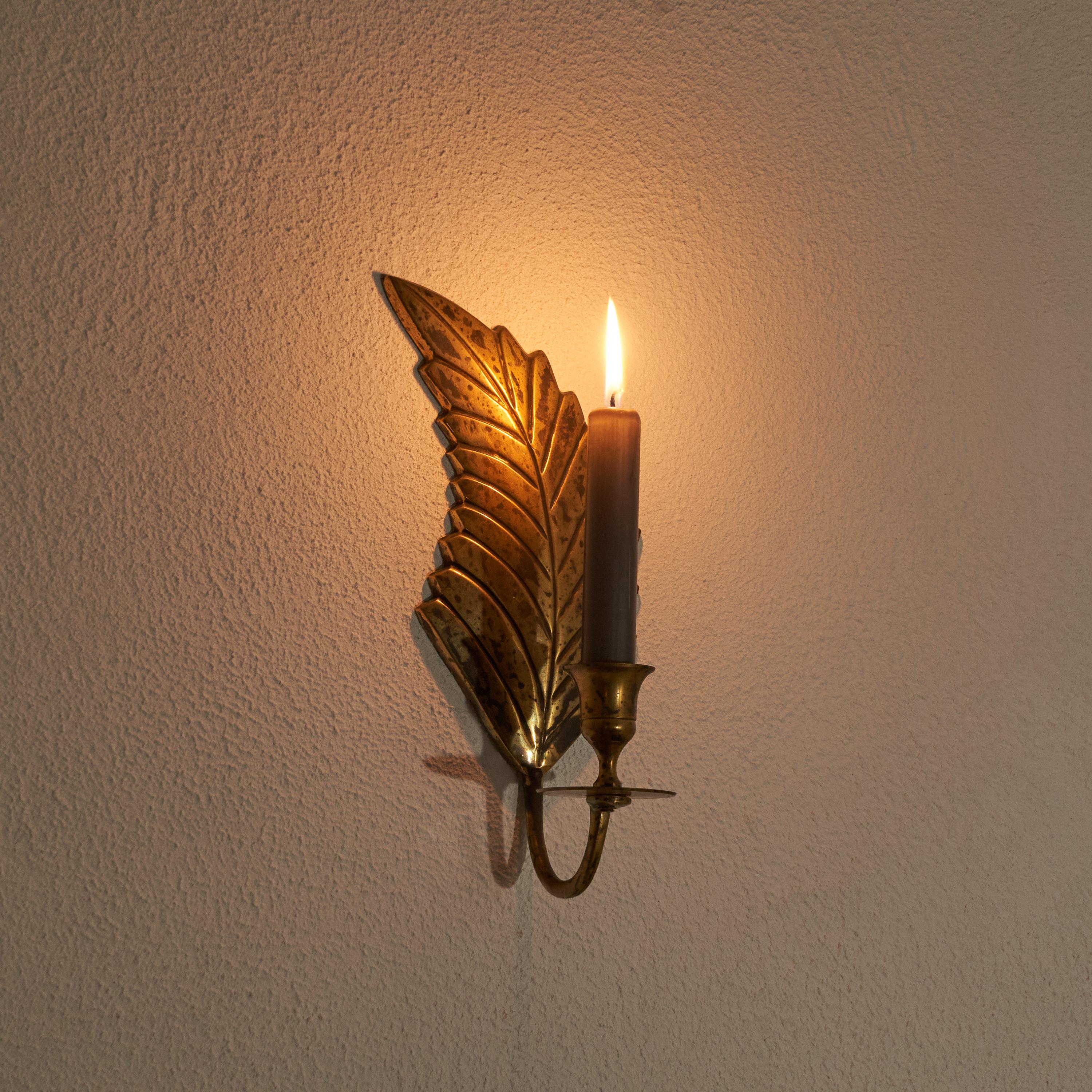 Leaf Shaped candle sconce in Patinated Brass 1970s.

Wonderful and elegant candle sconce in the shape of a leaf. Made in brass, this candle sconce makes sure the light is reflected in a warm and cozy way. The brass surface is patinated, which only