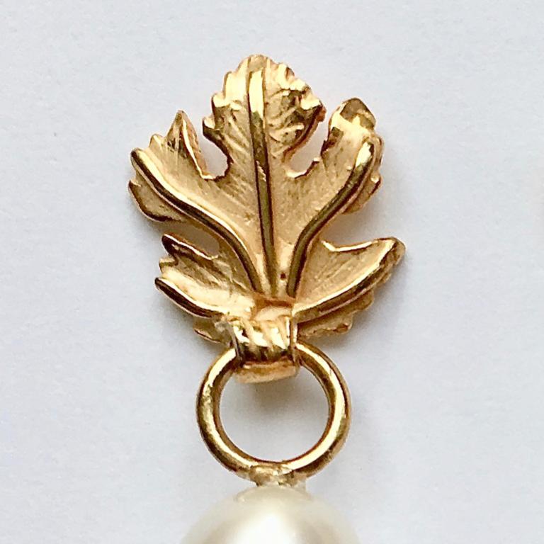 Leaf top cream freshwater pearl earrings in 18 carat yellow gold. With post and butterfly fittings.

Esther Eyre has been designing and making precious jewellery for over twenty years. She trained at Kingston and Middlesex gaining a BA in jewellery