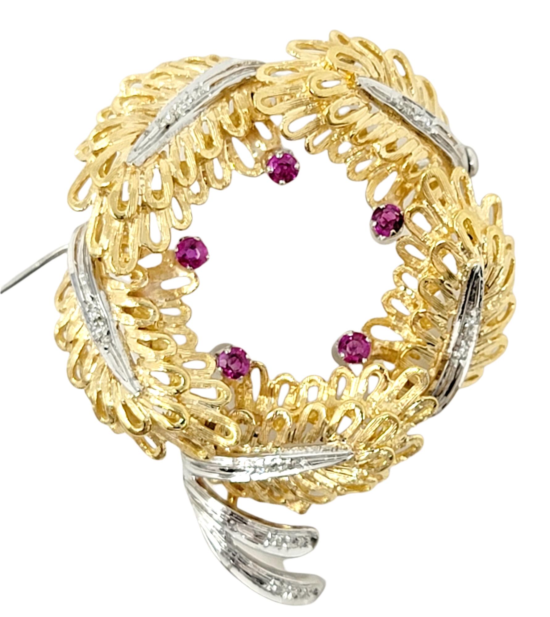 Beautifully textured 14 karat gold wreath brooch with sparkling diamond and ruby details. 

Metal: 14K Yellow and White Gold
Closure: Hinged stick pin
Natural Rubies: .20 ctw
Natural Diamonds: .10 ctw 
Diamond Cut: Round Brilliant
Diamond Color: