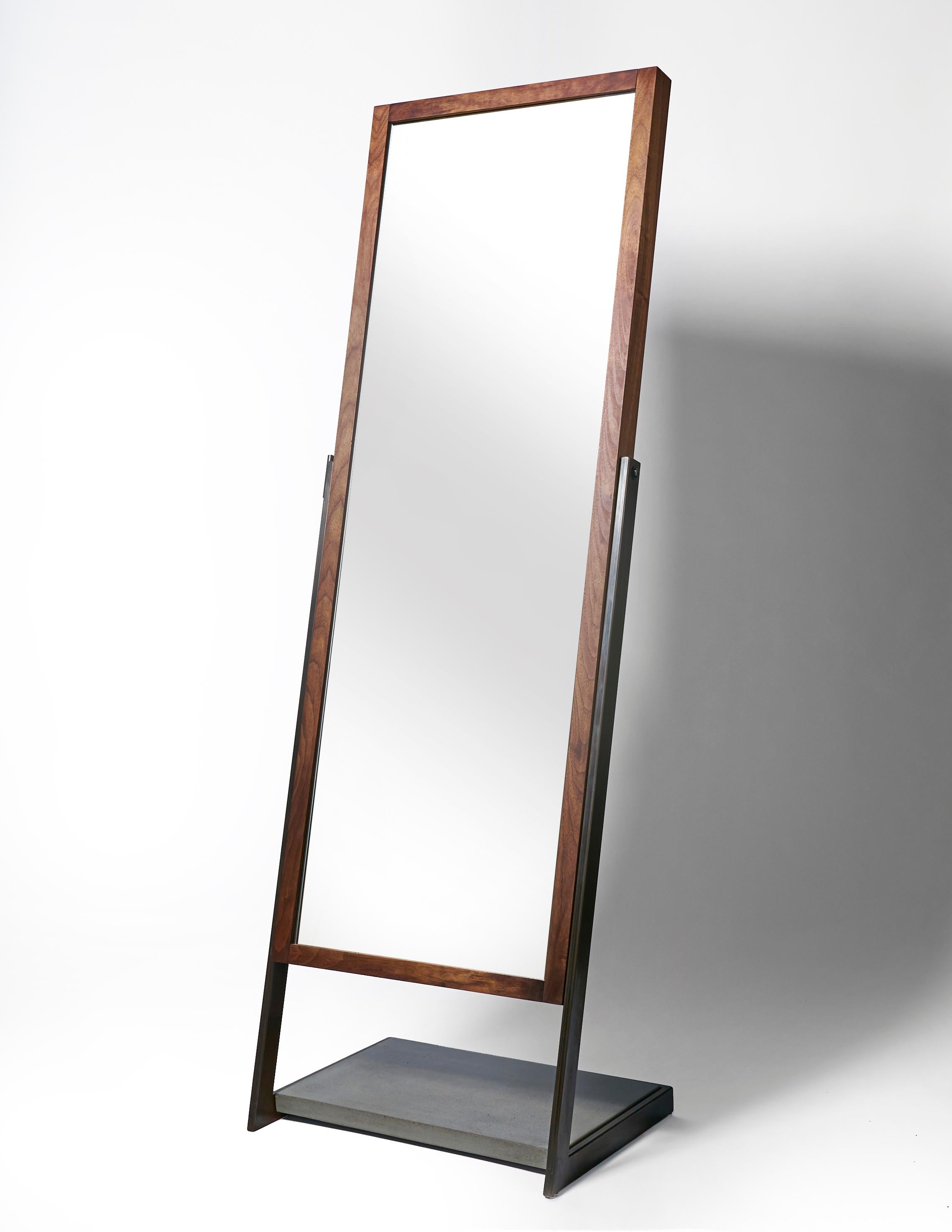 Full length mirror imagined in a new way with a perfect balance in both materials and lines. A wrap around hand blackened steel frame holds a lower platform section of charcoal concrete at the base. Suspended in this frame is a full length mirror