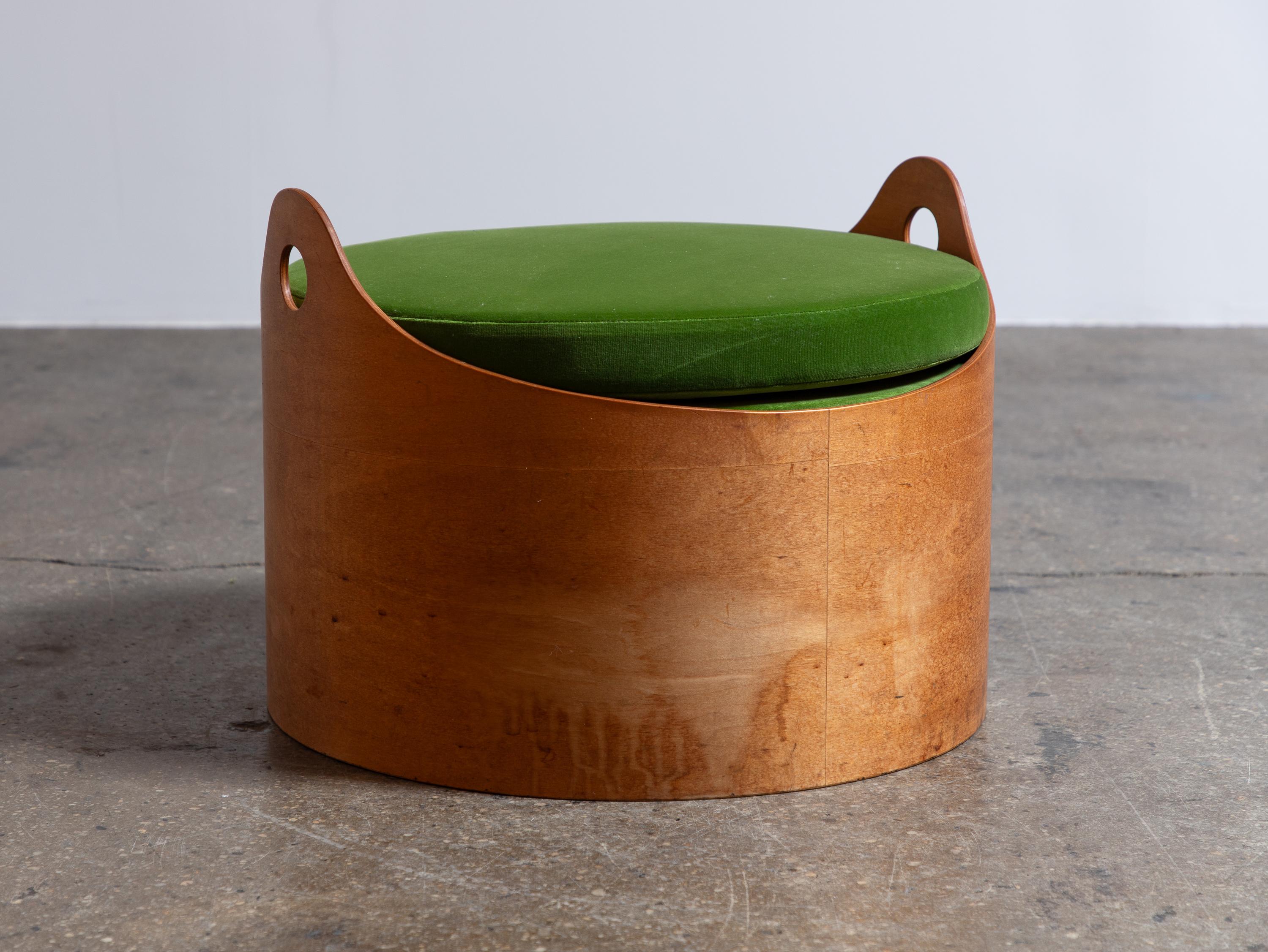 Modernist bent ottoman with velvet cushion, designed by architect Leandre Poisson. The ottoman is comprised of a curved plywood base finished with two charming handles. We added a loose round cushion in grass green cotton velvet. This example is