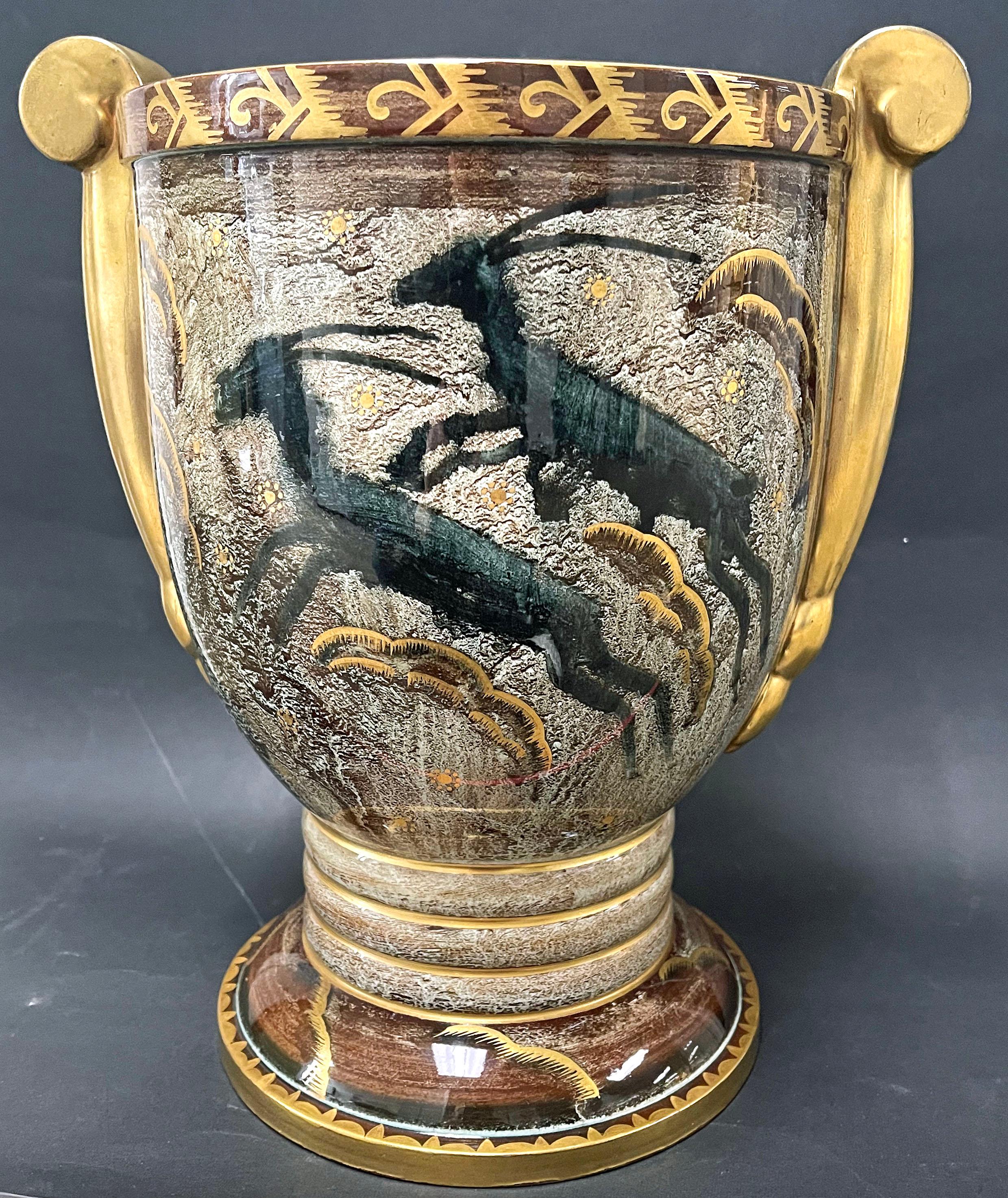 This very early example of Art Deco artisanry, dating from around 1917 just before Josef Ekberg left the Gustavsberg porcelain works in Sweden, is richly decorated with leaping gazelles accompanied by stylized clouds of gold superimposed over a