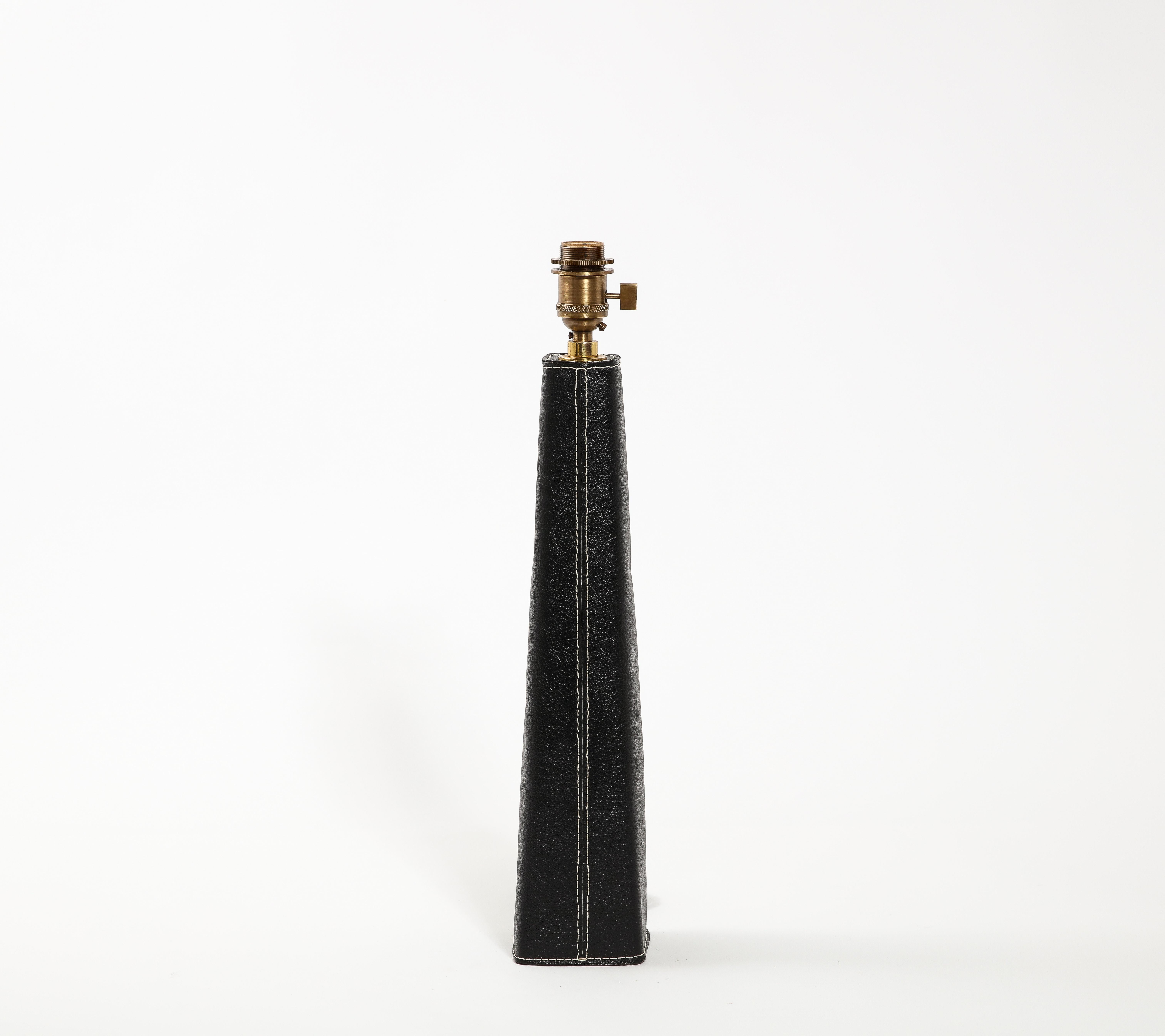 Tall obelisk-shaped lamp by Metalarte of Spain, covered in leather and stitched along the base and stem. Signed underneath. Size is of the base only. No shade included.