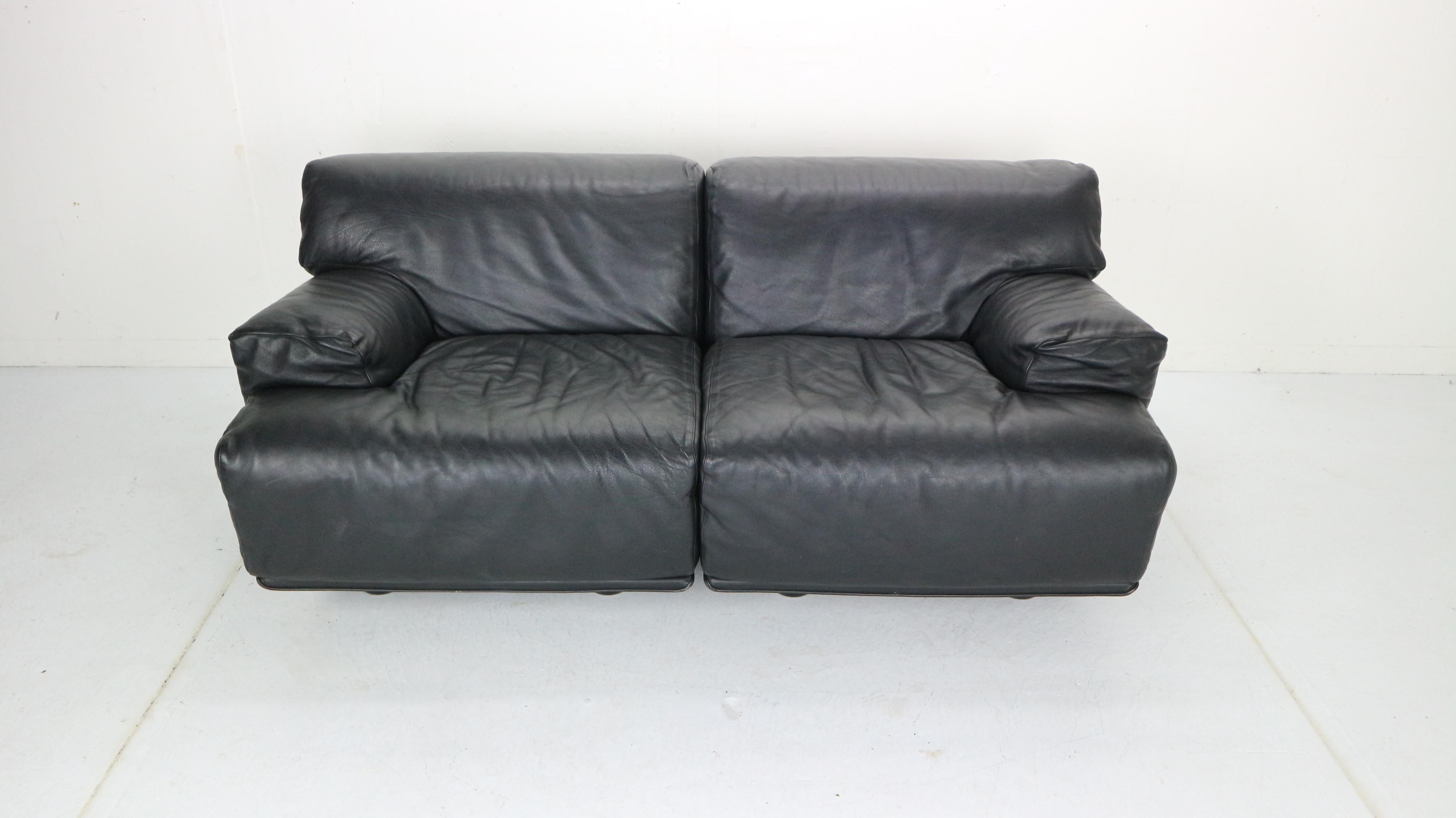 Two-seat sofa designed by Vico Magistretti and manufactured by Cassina in 1970s period, Italy.
Model: Fiandra.
Modular sofa can used as two-seat sofa or two separate lounge chairs.
Black leather seating’s in a very good condition.
         
