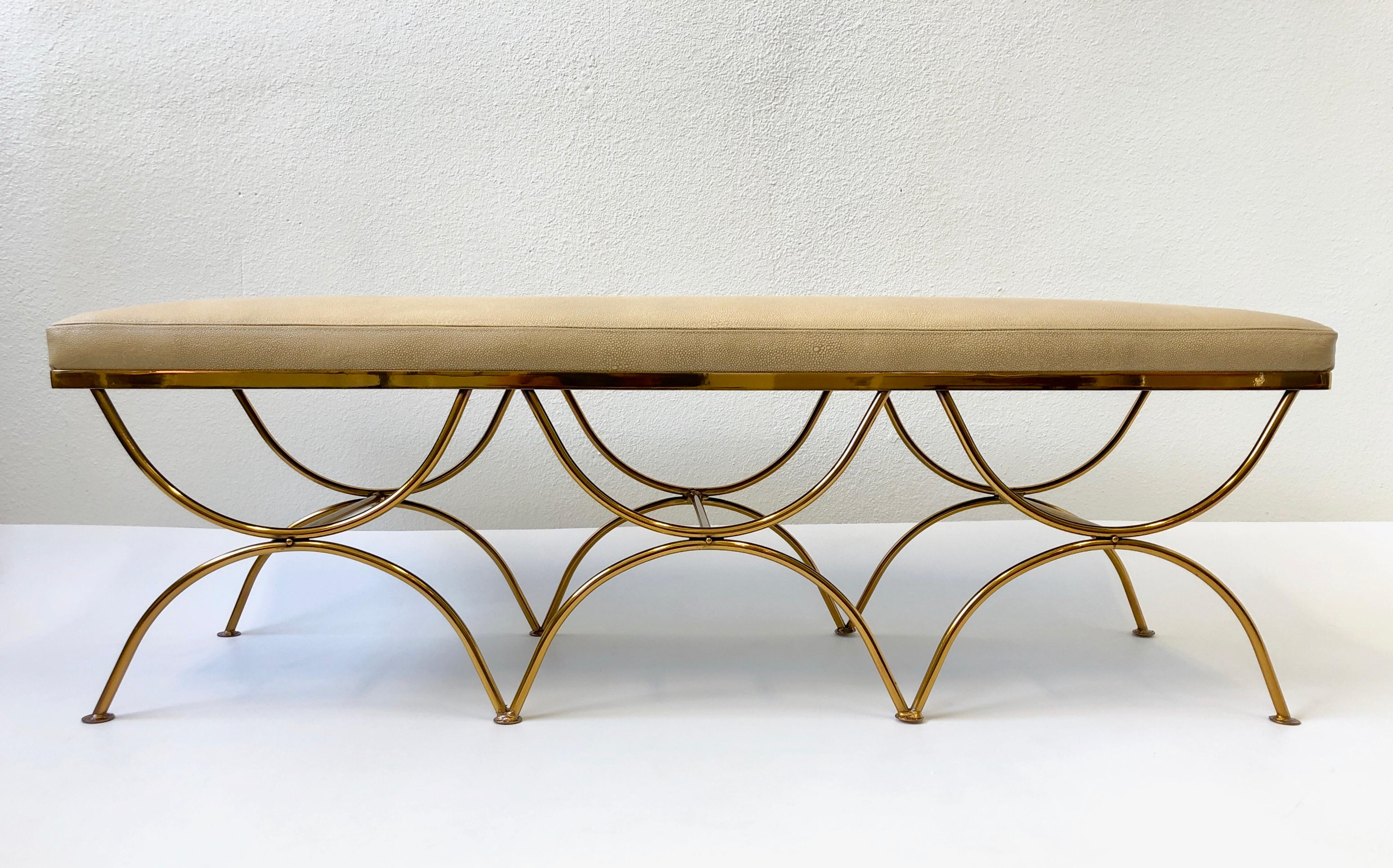 A glamorous 1950s Bench. The bench has been newly recovered in a Italian beige shagreen embossed leather and the base has been newly powder coated gold. 

Dimensions: 18” high, 54.5” wide, 16.5” deep.