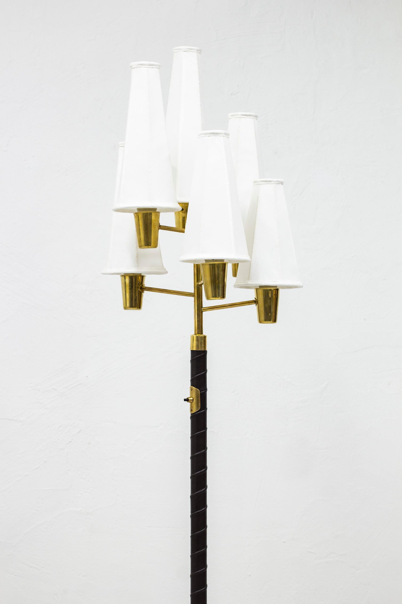 Very rare Swedish modern floor lamp designed by Hans Bergström. Produced by his company Ateljé Lyktan in Sweden during the 1940s. Made from brass and aubergine/ almost black leather. Six arms with asymmetrical shaped/sized chintz lamp shades. Light